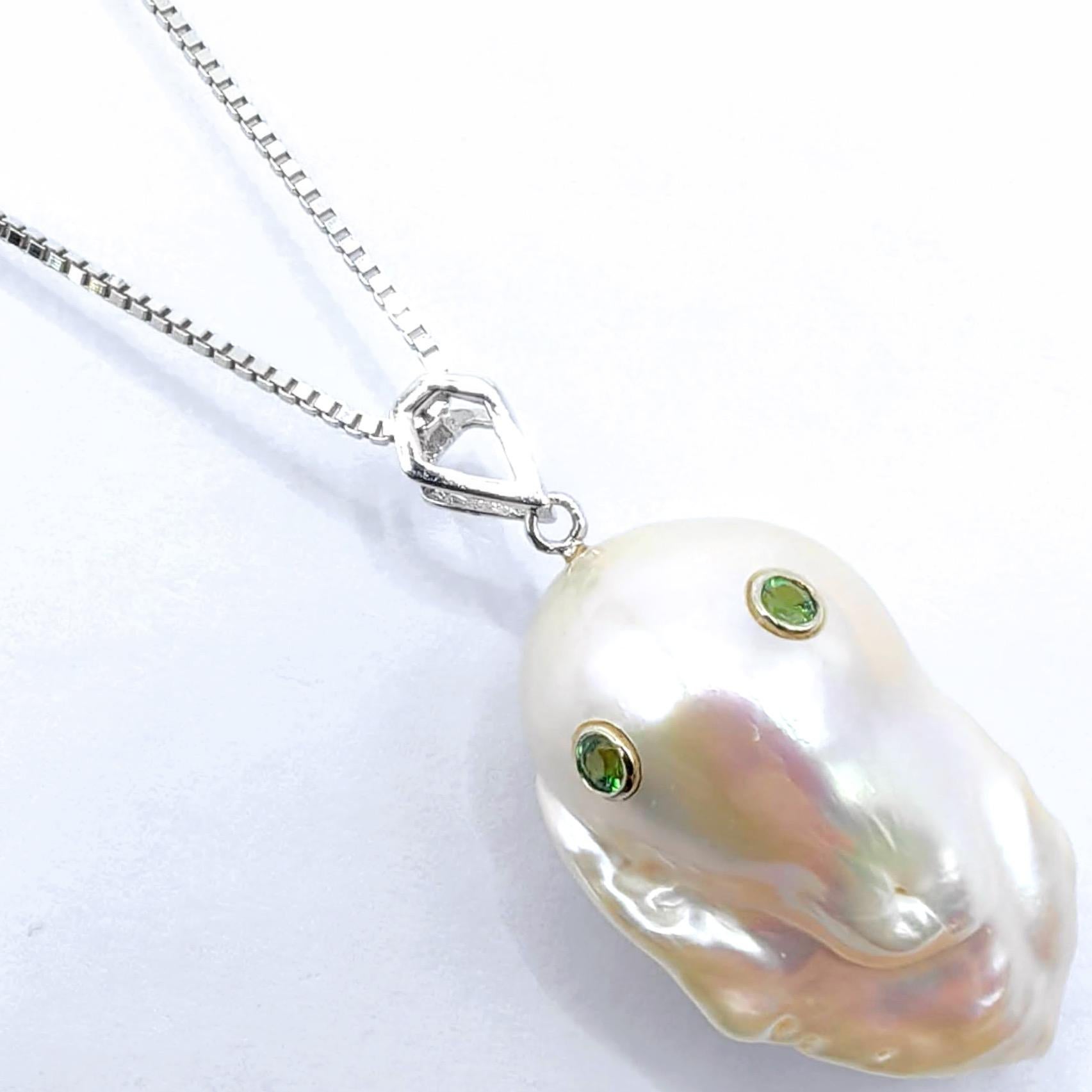 A mesmerizing blend of ethereal beauty and contemporary design, this beguiling ghost pendant in 18K white gold brings spectral charm to life with refined artistry. At the center of this creation rests a stunning 19.20-carat baroque cultured