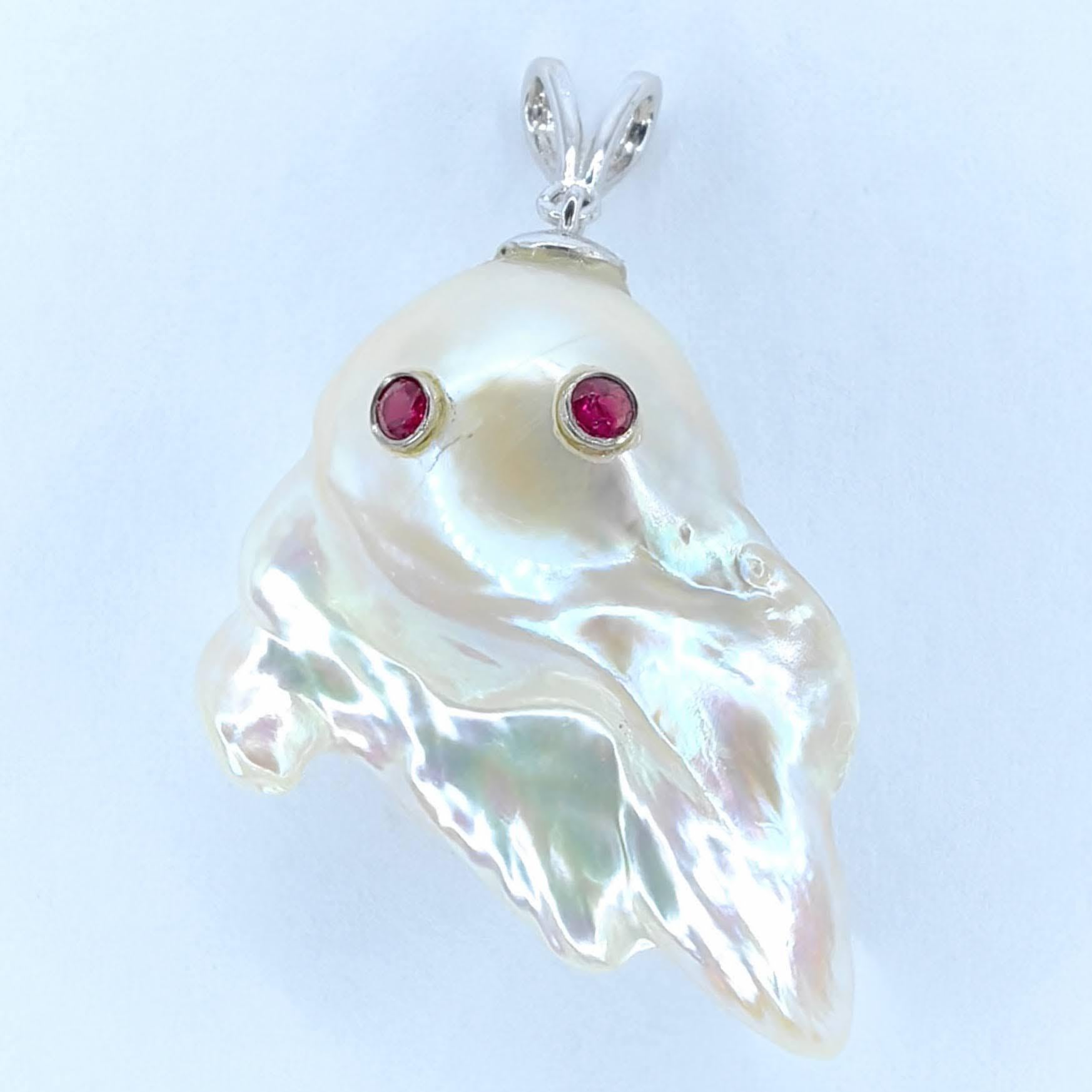 Unveil the enchanting Darling Phantom: a whimsical marvel featuring Ruby accented Baroque Pearl set in 18K White Gold, evoking the spirit of a mischievous yet charming ghost. This captivating piece, with a pendant length of approximately 1.32 inch
