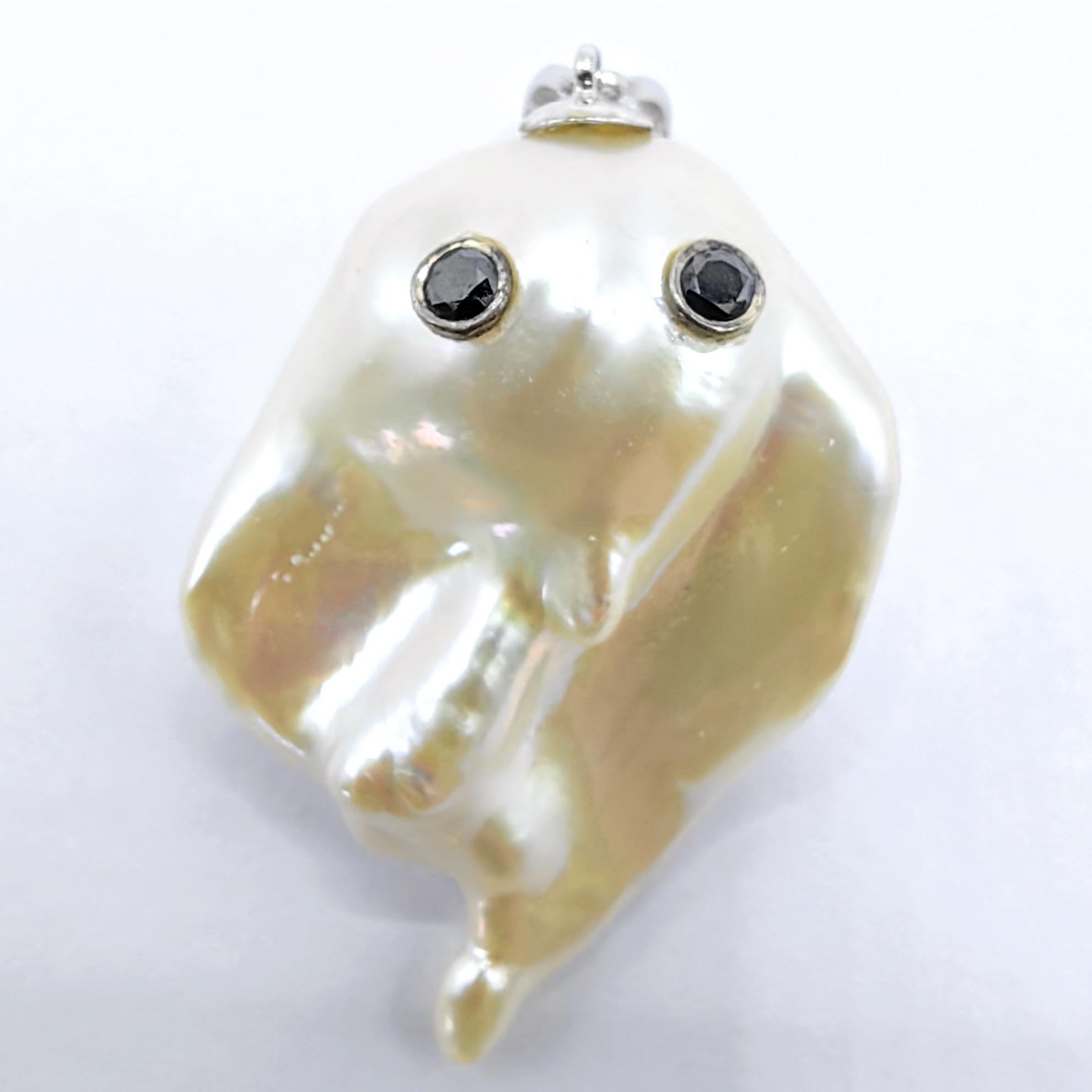 An extraordinary fusion of whimsical artistry and exquisite craftsmanship, this commanding ghost pendant in 18K white gold elevates playful imagination to grand proportions. At the heart of this exceptional creation rests a magnificent 30.33-carat