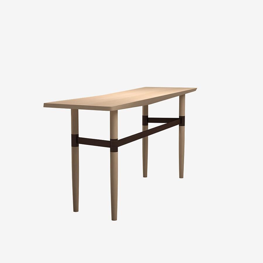 This Darling Point console by Yabu Pushelberg in nude brushed ultra matte lacquered oak is paired with a golden or bronze coloured brass finish frame.

Yabu Pushelberg’s design for the Darling Point console is hand-hone by craftsmen from