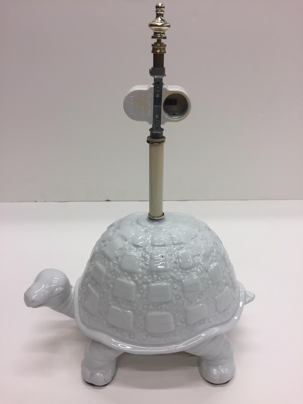 A wonderful decorative table lamp in the shape of a curious white ceramic turtle. Shade not included.