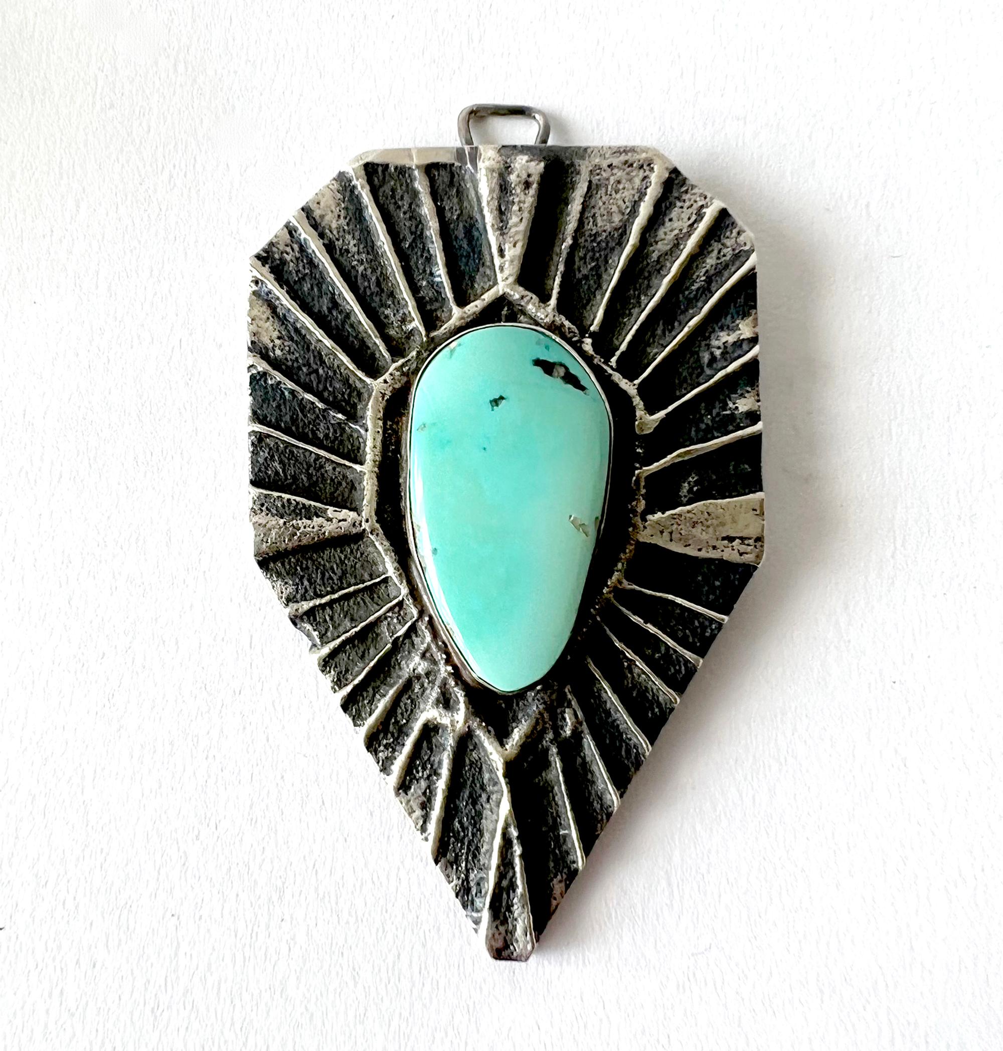Tufa cast sterling silver and turquoise pendant created by Native American jeweler Darrin Livingston.  Pendant measures 3 3/8