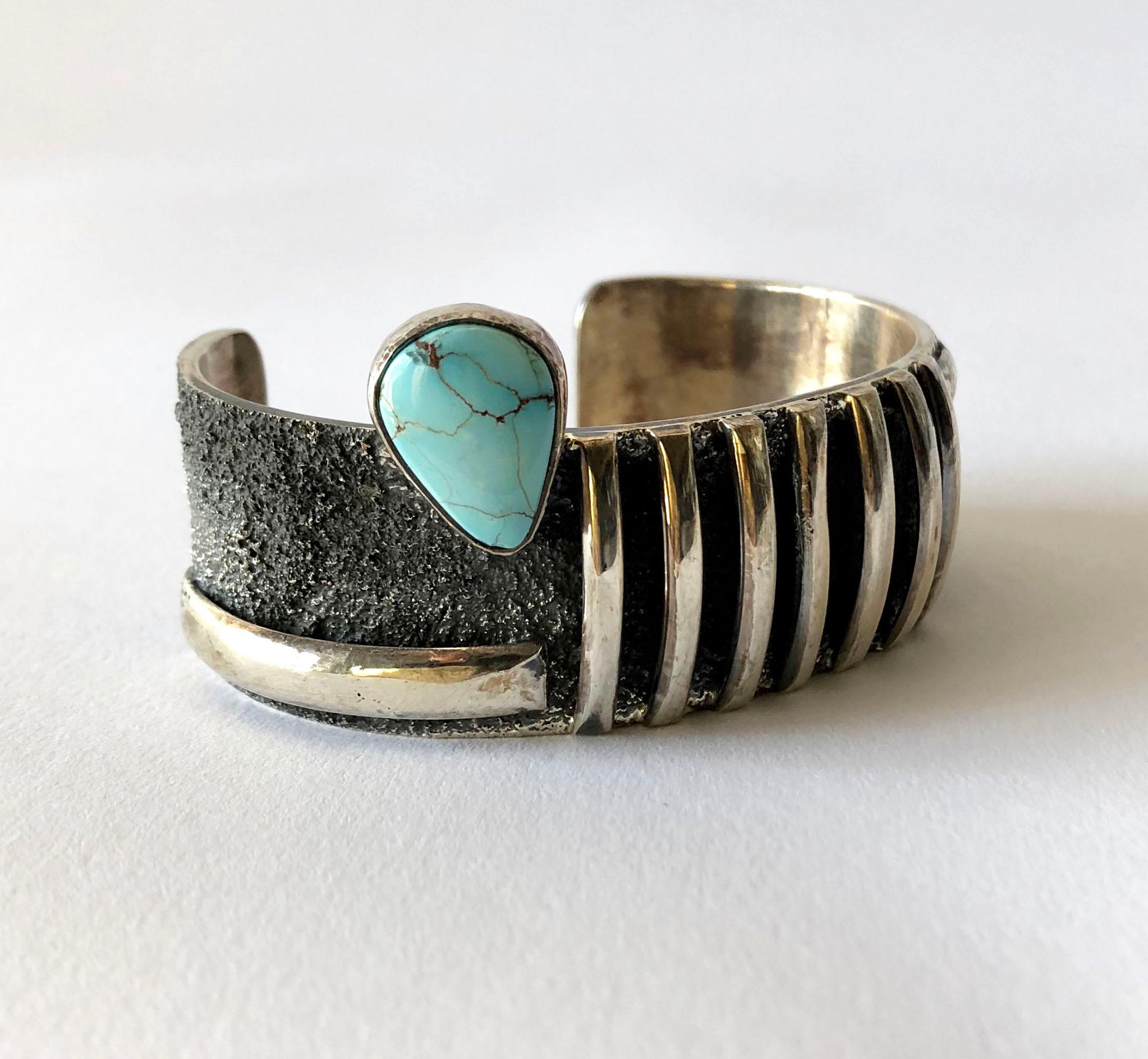 Native American sterling silver cuff bracelet with candelaria turquoise designed by Darrin Livingston. Bracelet measures 1