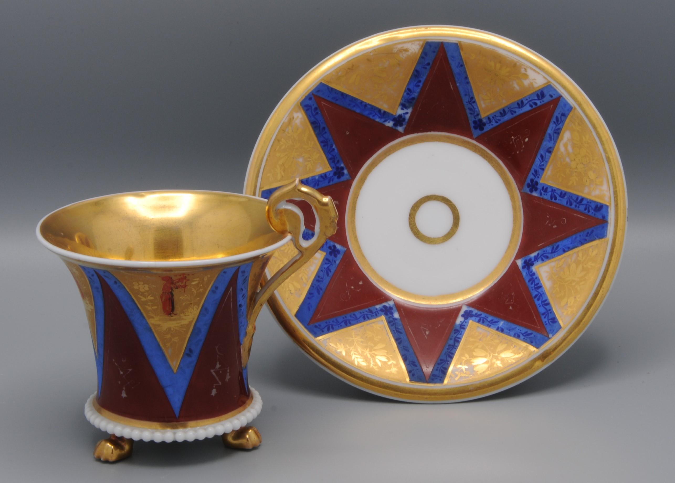 Marvelous cup and saucer, elaborately decorated with geometrical forms in red, blue and gold. Beautifully worked gilding, little details of Chinese figures and Chinese characters.  
Possibly made Darte Frères factory, Paris, ca. 1815
No marking, but