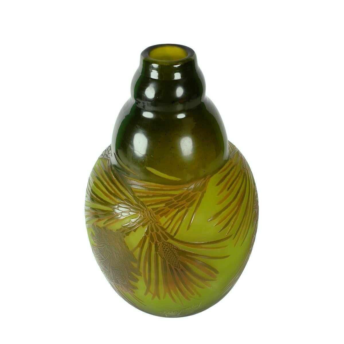 Offering this vintage D'Argental “Pine Cones” cameo relief art glass vase. This acid etched and polished cameo vase has a detailed pinecone and pine needle design a deep olive green to amber color against a pale green to amber body. Vase is acid