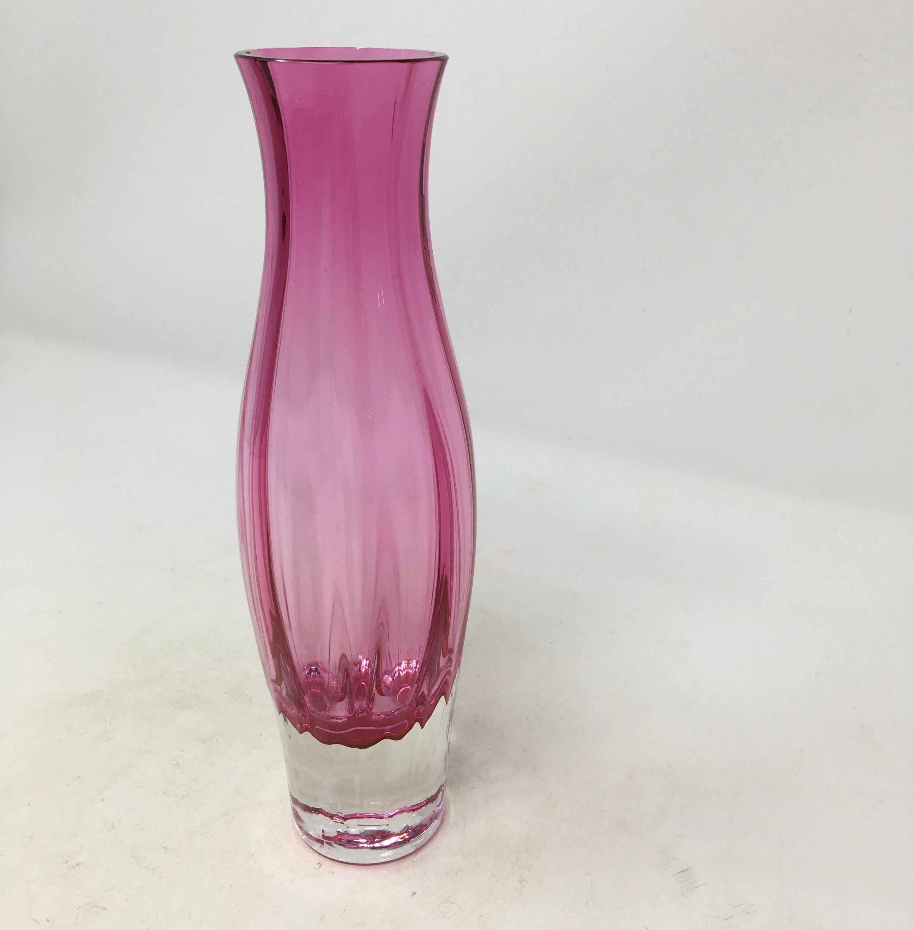 This is a beautiful cranberry color glass vase made in England by Dartington. Lovingly handcrafted in Devon, this vase will add a pop of color to your home.

This piece weighs 1 lb.