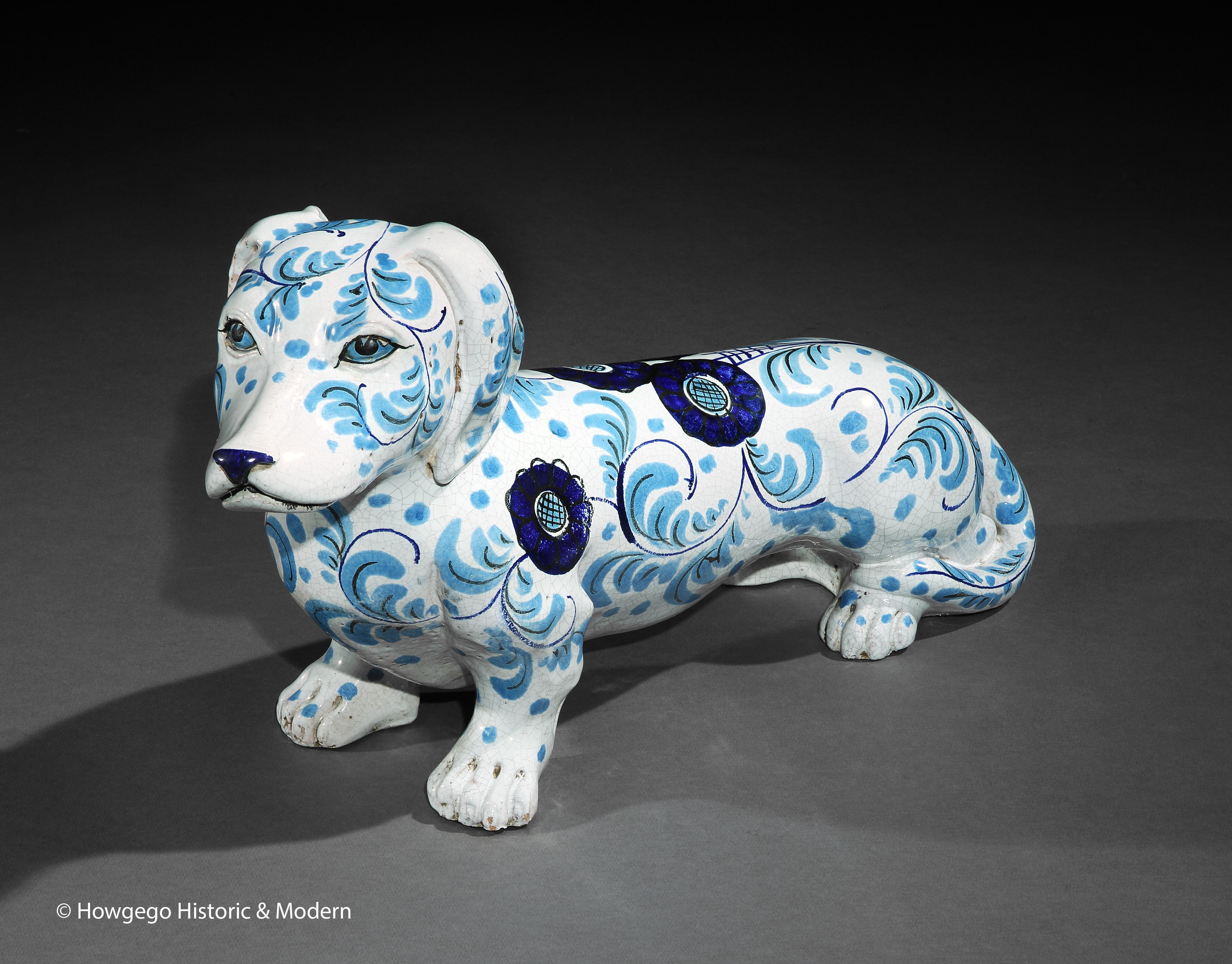 Life-sized, standard Daschund, ceramic sculpture suitable for the home or garden
The blue and white stylised flowerhead and trailing acanthus leaf decoration is unusual and fun, evoking the flower-power of the 1960's
This sculpture has been