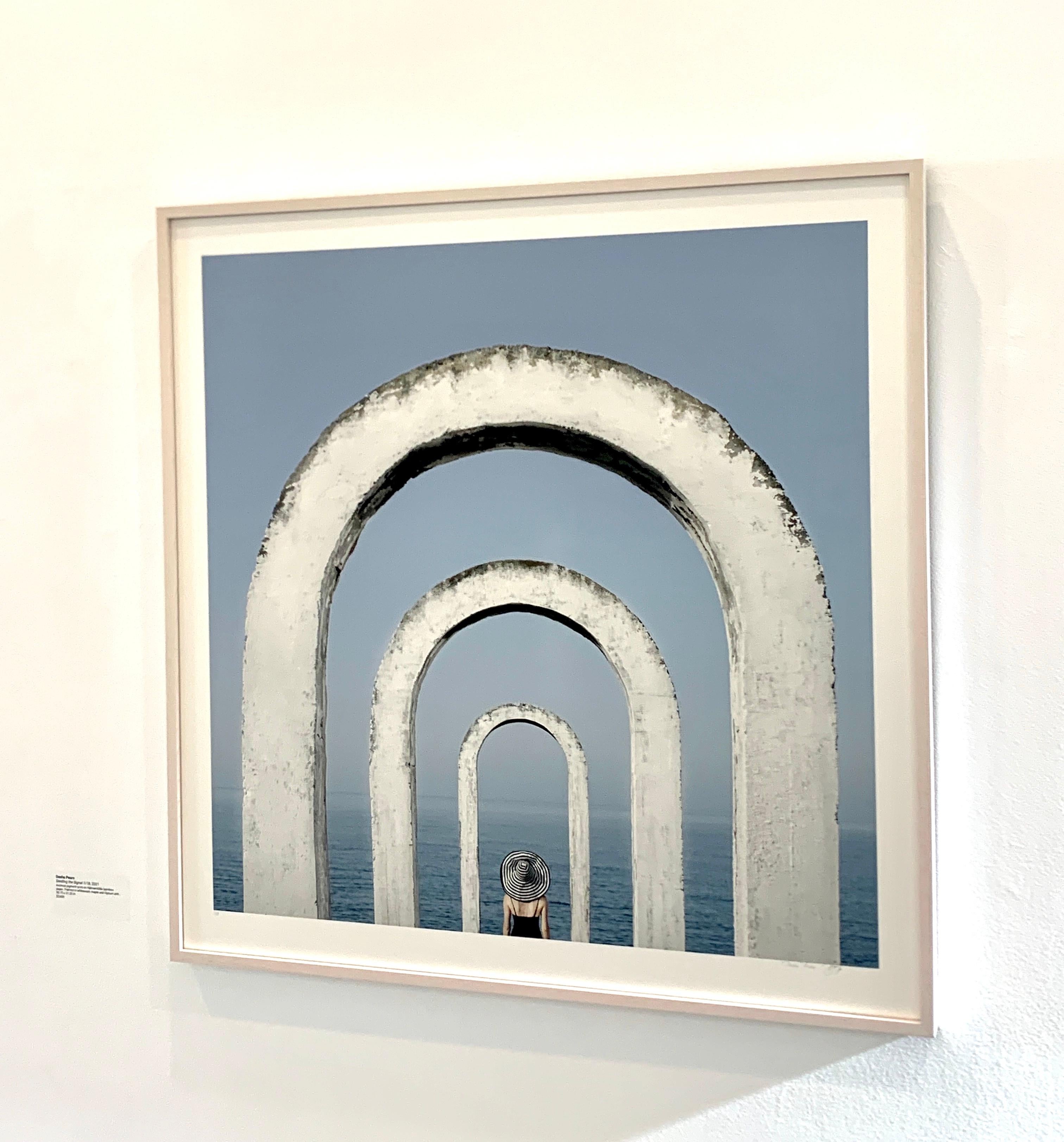 Framed Color Photograph: Woman at blue ocean w/ white arches looking at horizon For Sale 3