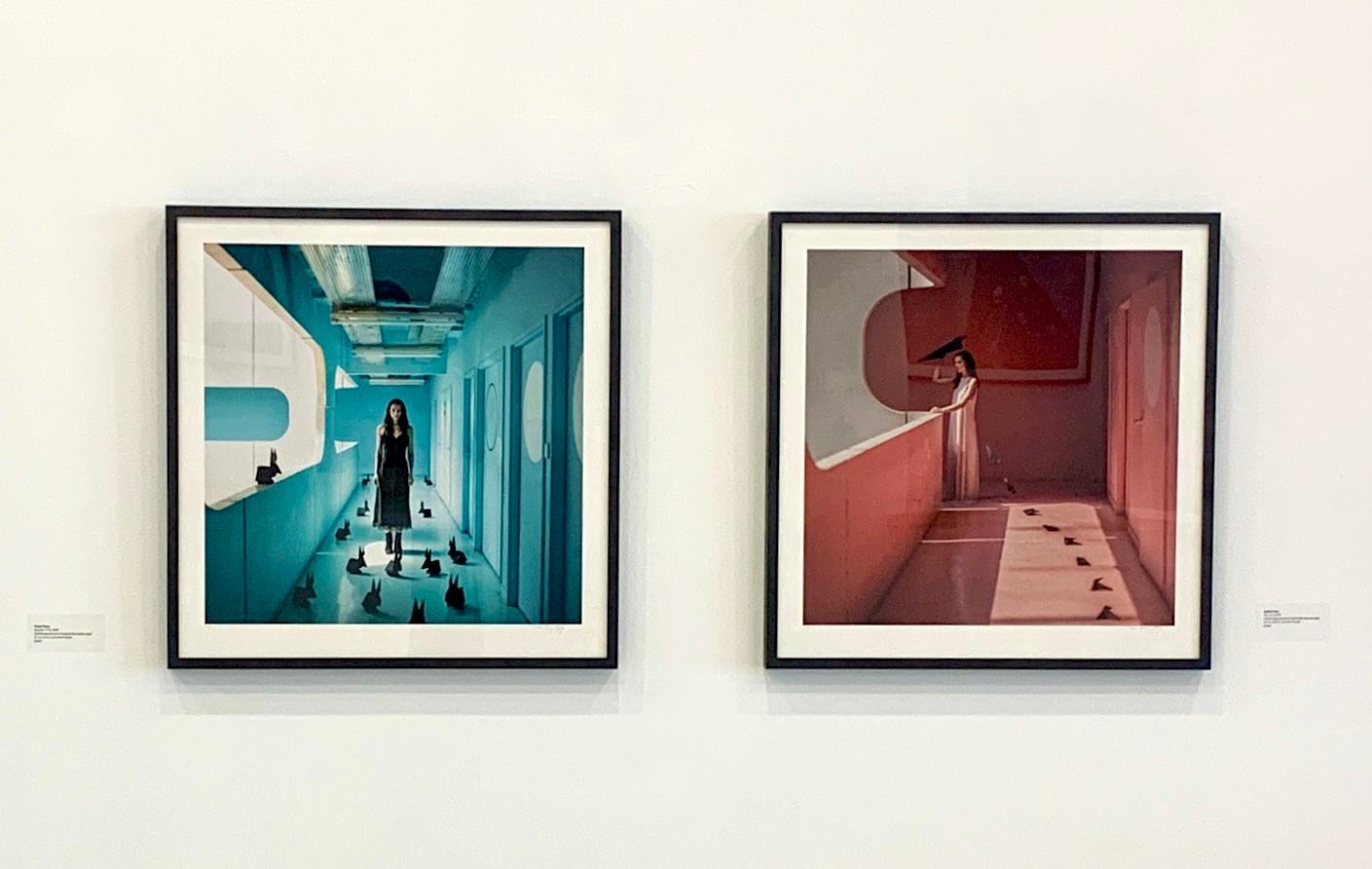 Piccola fotografia a colori incorniciata Donna in architettura rosa con origami - Color Photograph Marrone di Dasha Pears