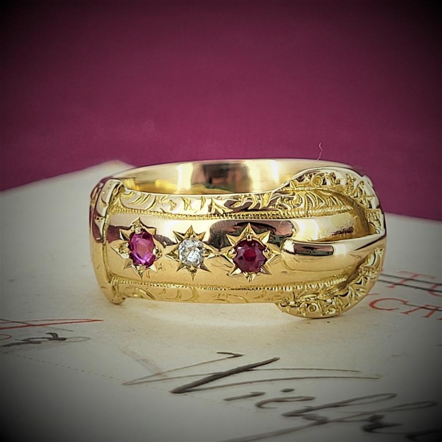 Date 1898! Wow! Just Wow! How we adore this buckle ring in 18ct yellow gold originally hallmarked in Chester in 1898. In sublime condition and set with hand cut rubies and diamonds this really is a beauty! The belt on the buckle was purposely beaten