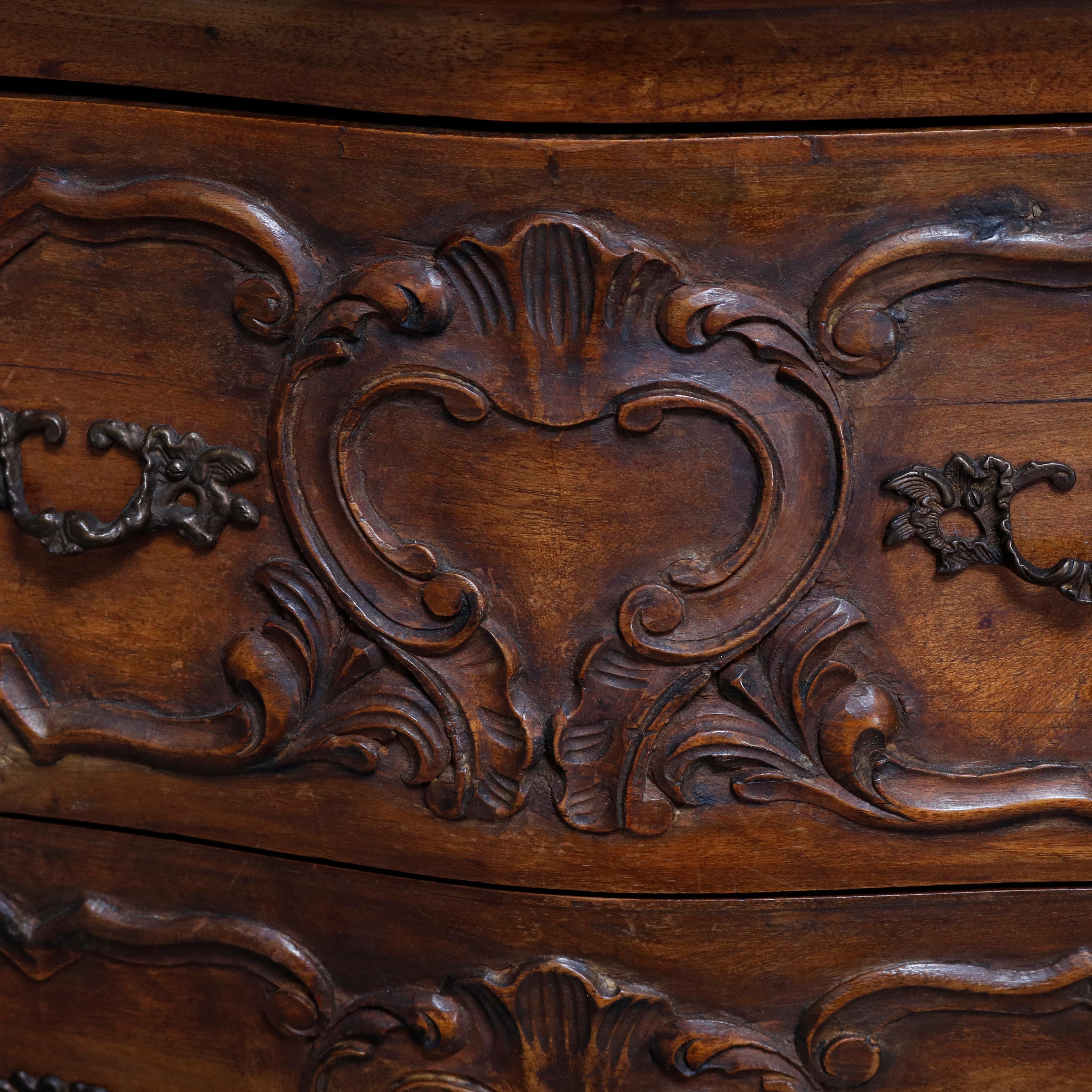 An Italian Rococo style chest offers walnut construction in bombe form with two drawers having carved scroll and foliate design surmounting pierced scroll and gadroon apron raised on cabriole legs, 20th century

***DELIVERY NOTICE – Due to COVID-19