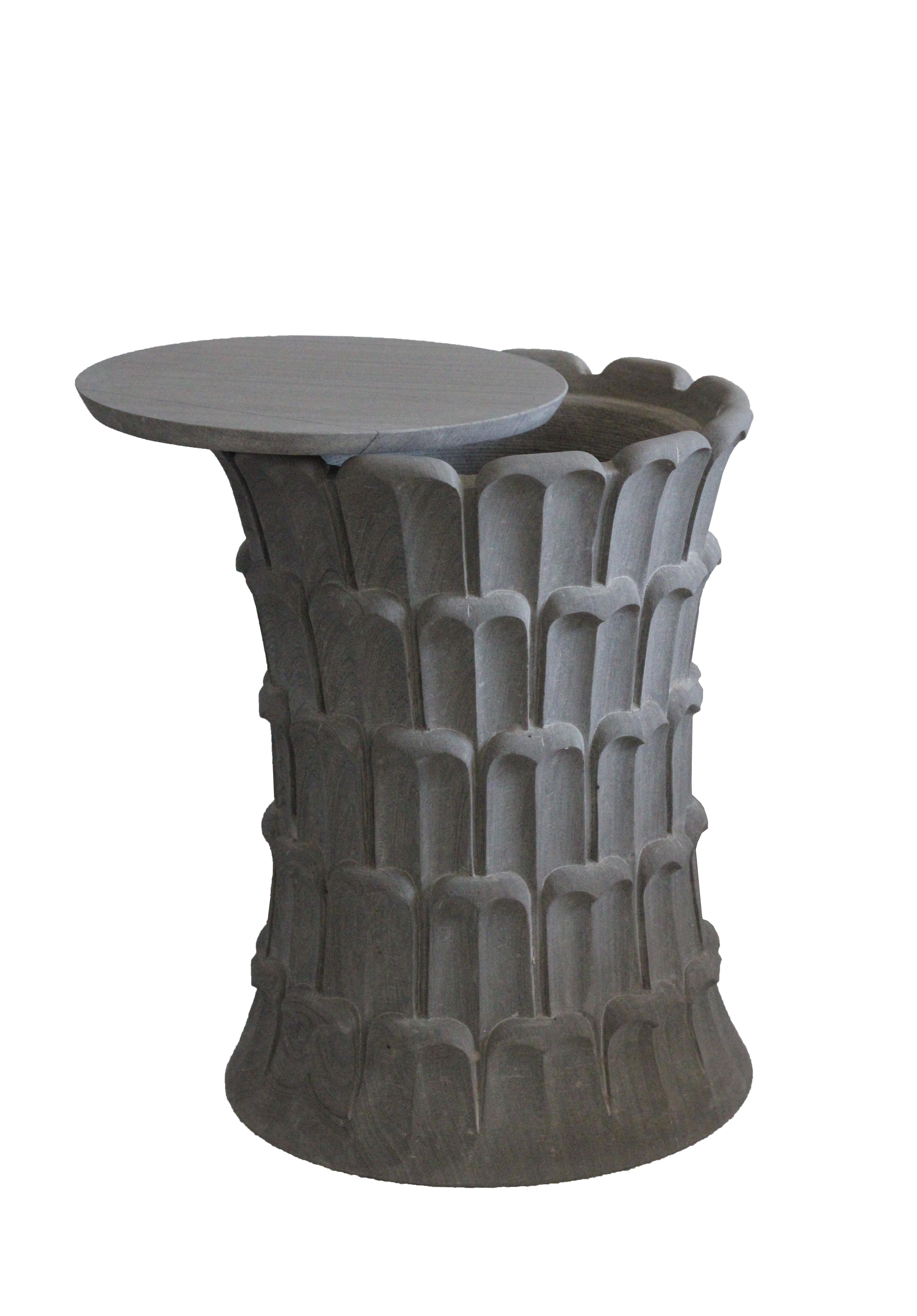 Inspired by the temple carvings in and around Udaipur, Stephanie Odegard designed this unique side table using locally available stones. The arrangement of the carved leaf motif resembles the leaf arrangement over the bark of a date palm tree. 
