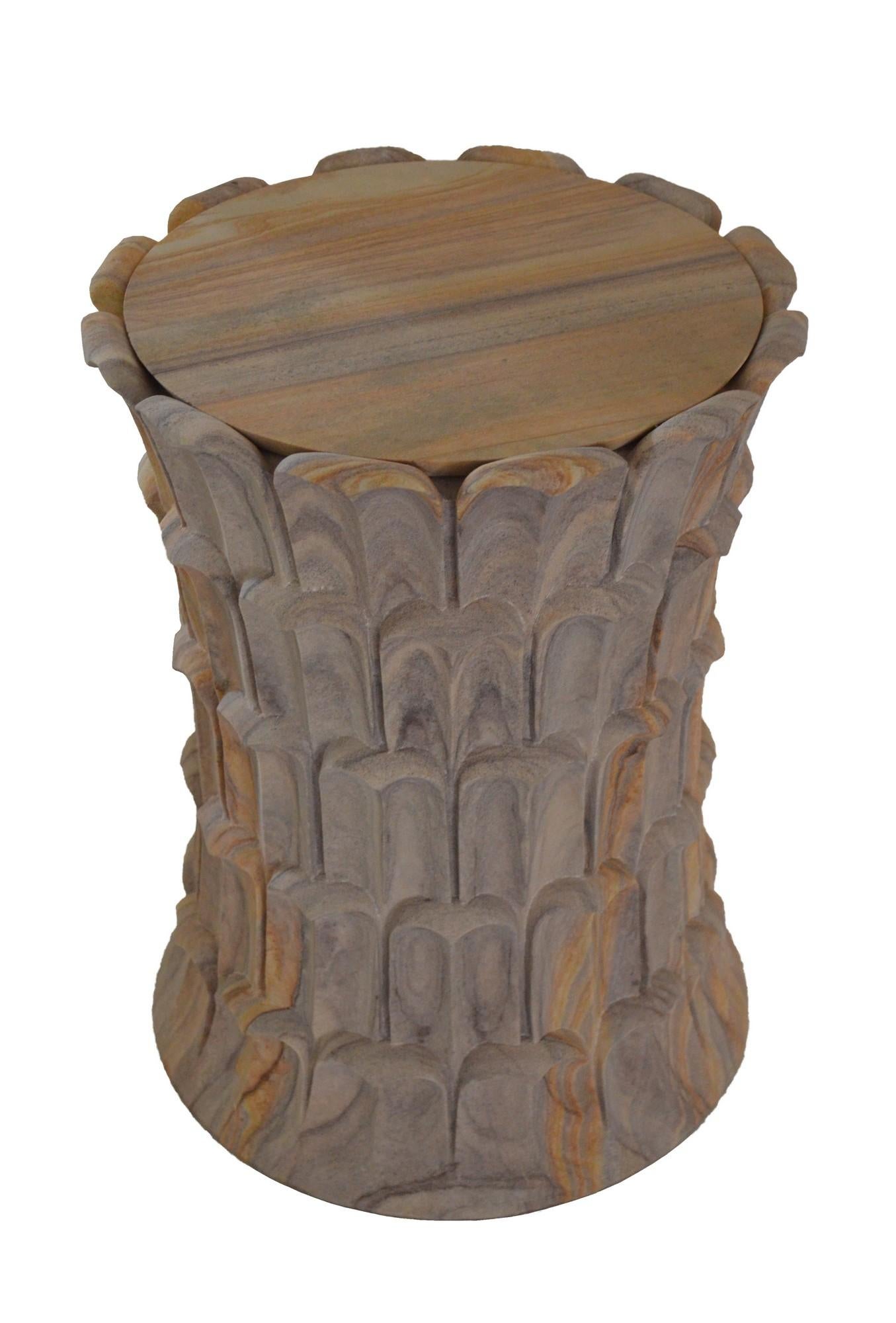 Inspired by the temple carvings in and around Udaipur, Stephanie Odegard designed this unique side table using locally available stones. The arrangement of the carved leaf motif resembles the leaf arrangement over the bark of a date palm tree.