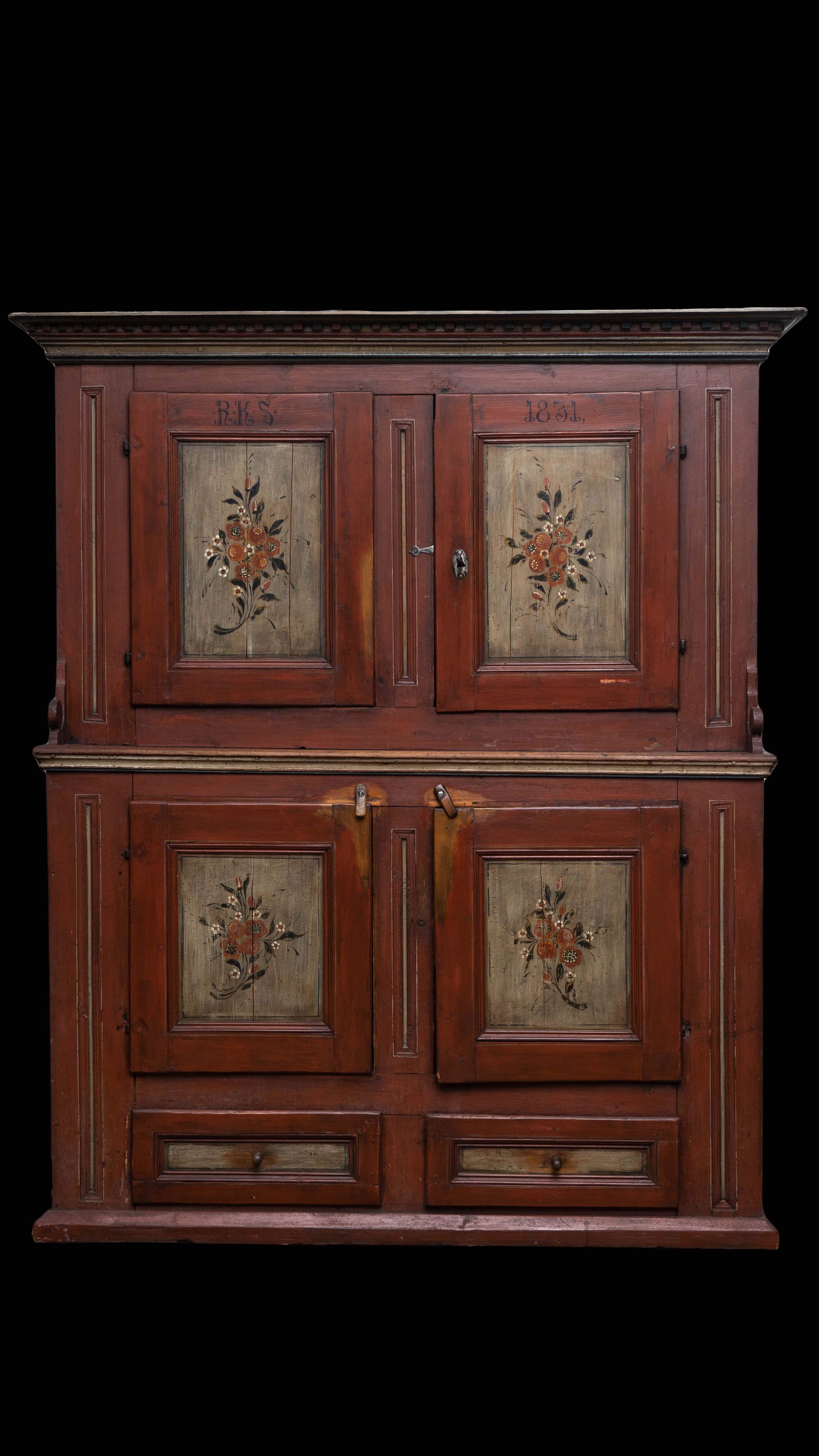 This is a antique Scandinavian cupboard made in 1831 from pine wood. This cupboard has a step-back design where the upper section is set back from the lower section. It has a robust, polychrome-painted dentil cornice at the top, which is a