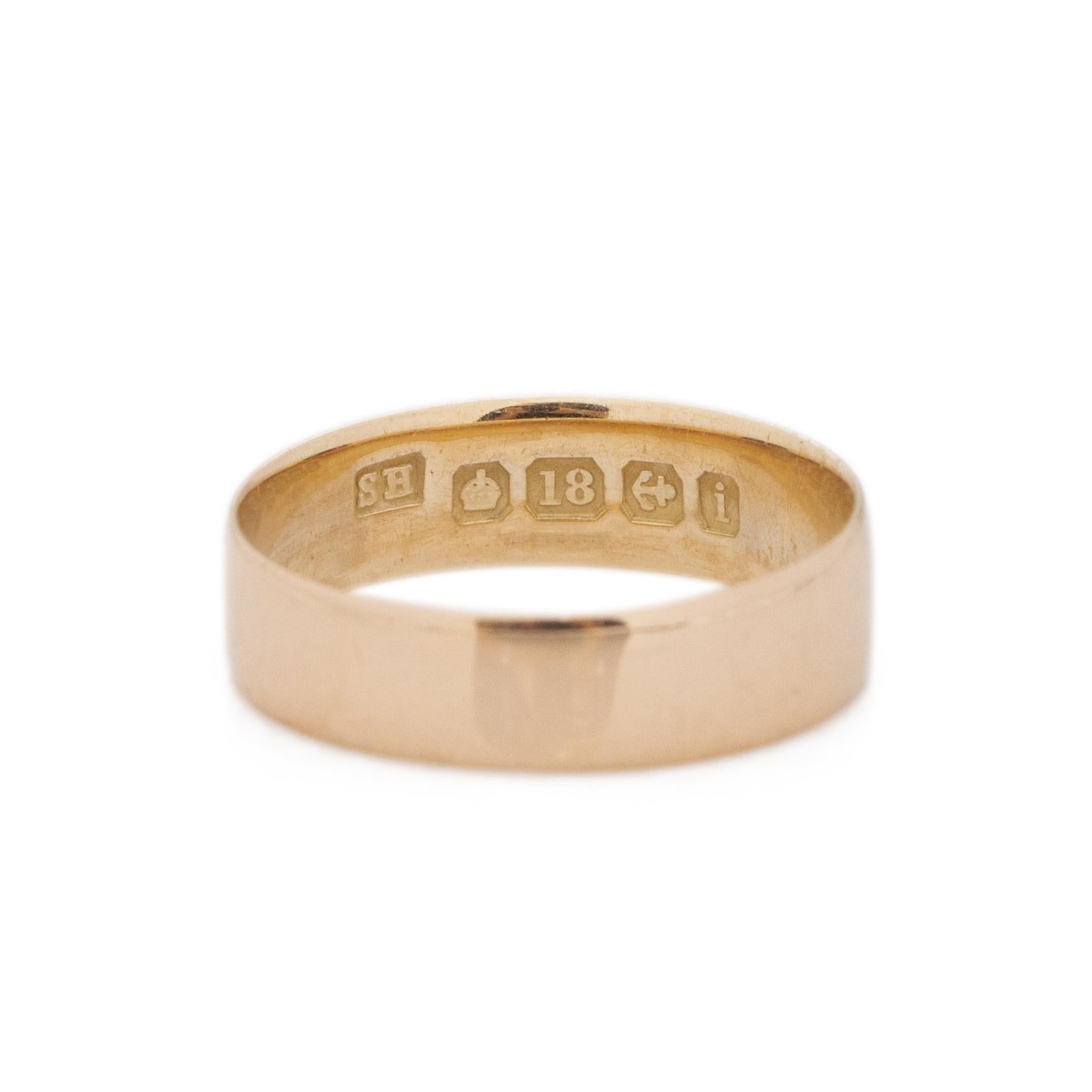 Here we have a classic band ring with beautiful British hallmarks. Crafted in 18K yellow gold, this band has a excellent smooth finish with a pristine shine. The hallmarks indicate that it is crafted in 18K, the anchor is the Birmingham essay stamp,