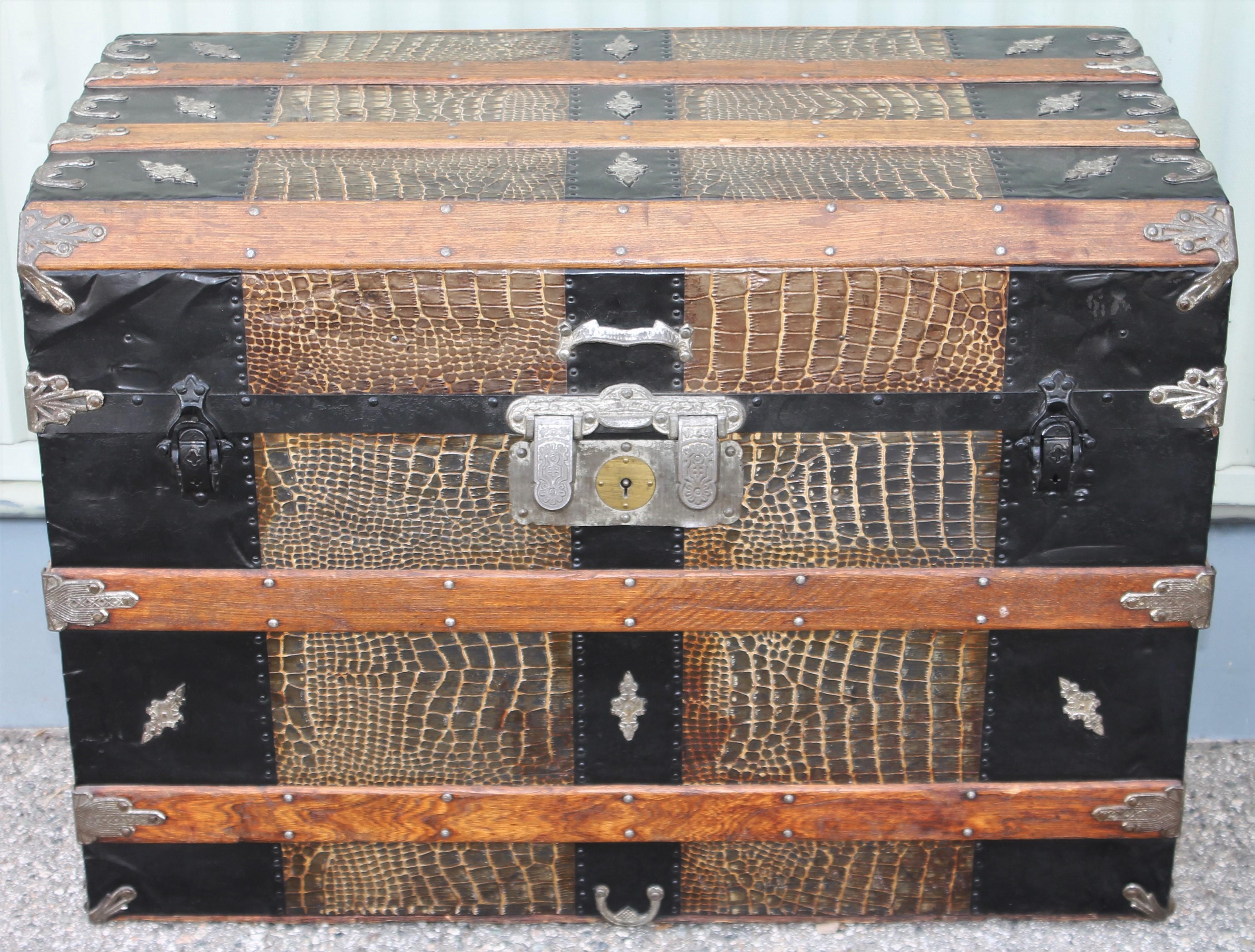 This fine signed by the manufacture FW GROMM, Denver, Colorado and dated 1877. This steamer trunk has all the original litho paper inside. The condition and the painted surface is pristine. The wood trim is also in fine as found condition.