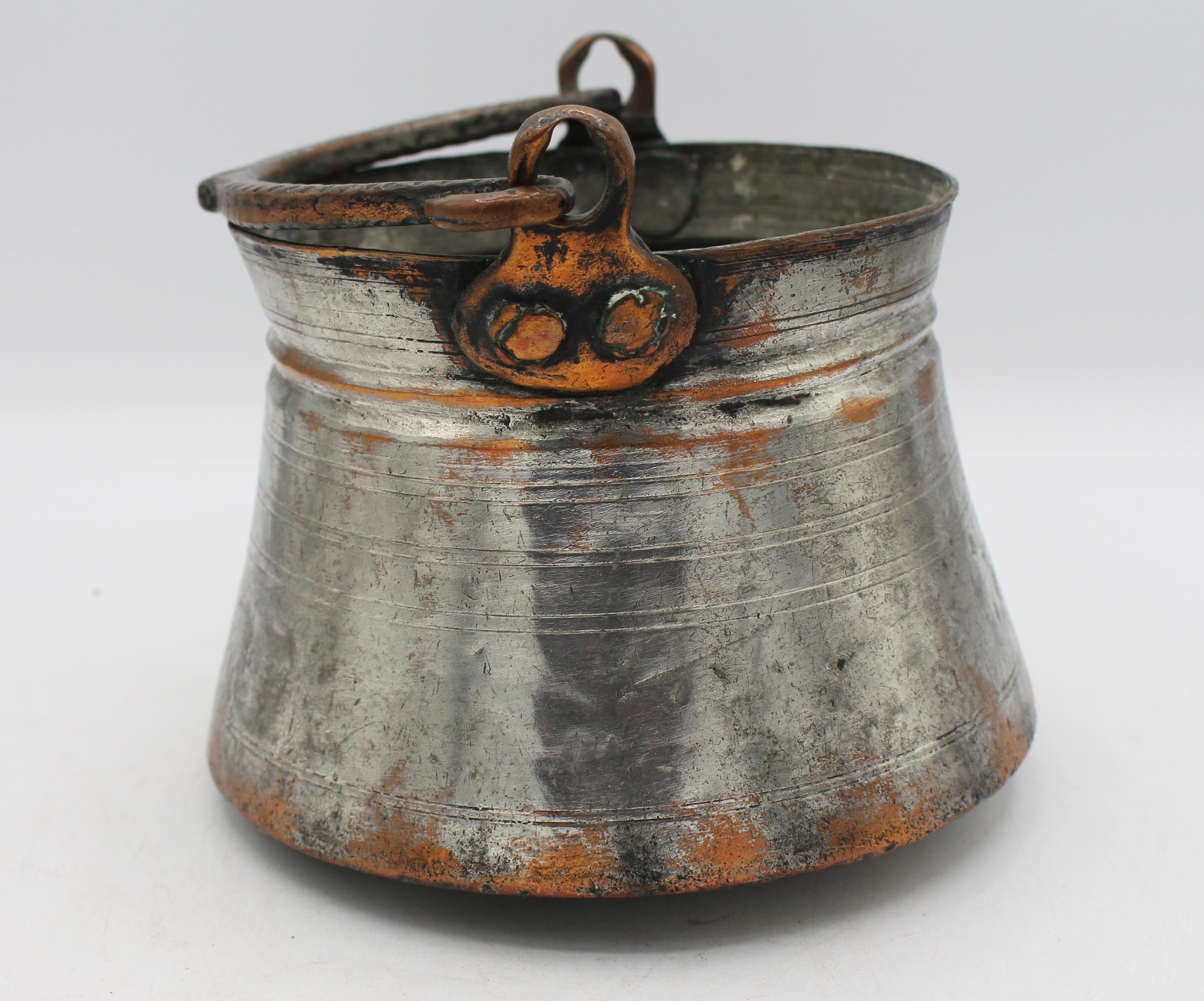 Dated 1894 Armenian tinned copper cooking or yogurt pot. Decorated with concentric incised bands, one with an inscription and date - rare to be dated. Hand raised 
forged. Copper swing handle. Well used.
7