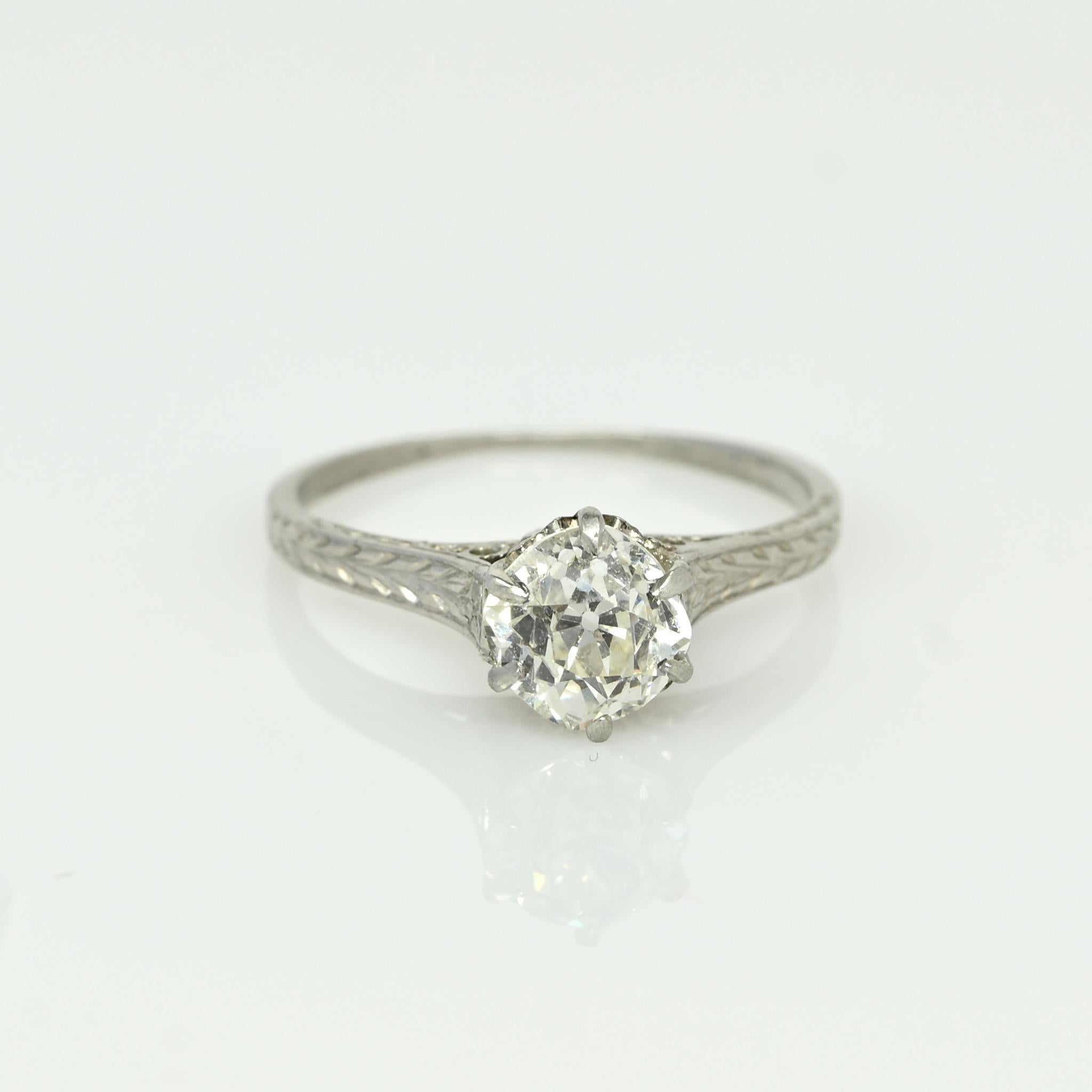 Presenting a gracefully understated Edwardian solitaire engagement ring. The centerpiece features an old European cut diamond cradled in a cathedral setting. Enchanting openwork graces the gallery, encircled by cathedral shanks adorned with a clean