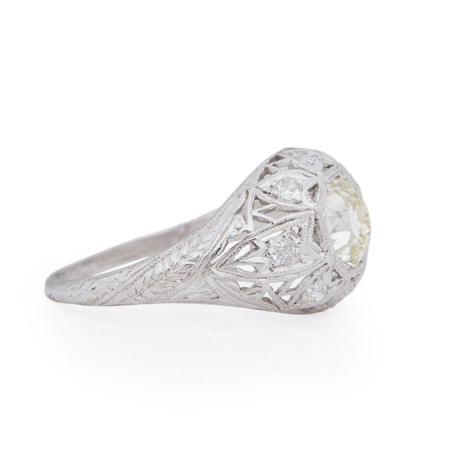 This captivating Art Deco ring showcases impeccable details, including delicate milgrain in the open work and lively diamond accents. Crafted in enduring platinum, this over 100-year-old piece features a timeless leaf design along the shank and a