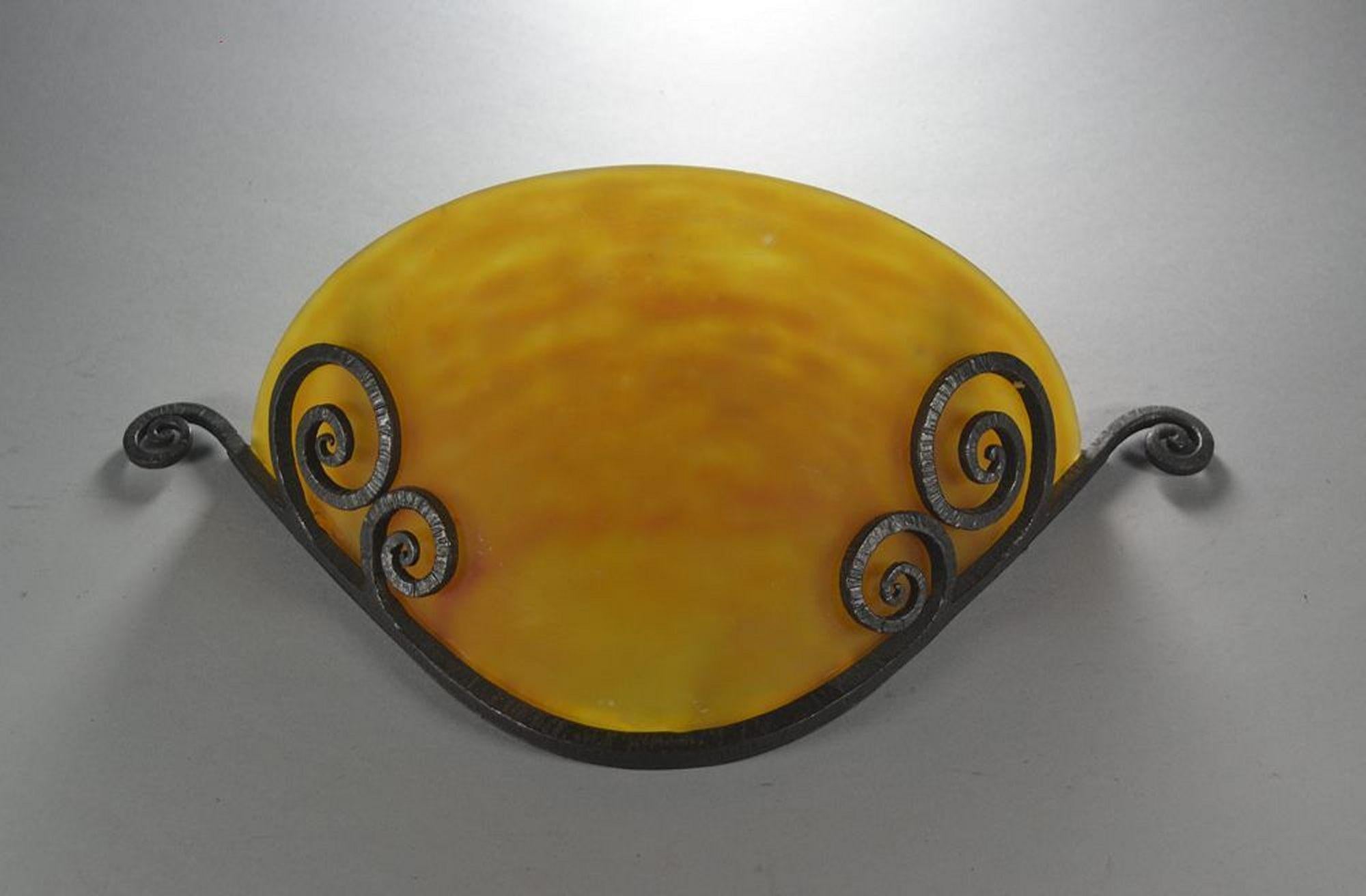 Edgar Brandt and Daum Nancy wall sconce.
Wrought iron fixture stamped with normal signature E. BRANDT.
Glass part signed DAUM Nancy.
Circa 1910.
Fixture excellent condition.
Glass with few small chips on edges not visible when in
