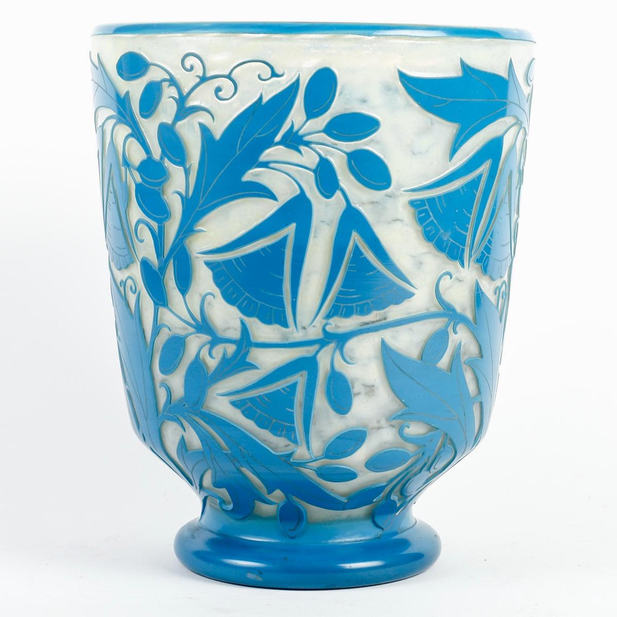 Daum Nancy France Acid-Etched Glass “Campanulas” Vase circa 1930
Vase with flared body and circular heel in blue glass with acid-etched hollow decoration of geometric campanulas on a white background 
Signed 