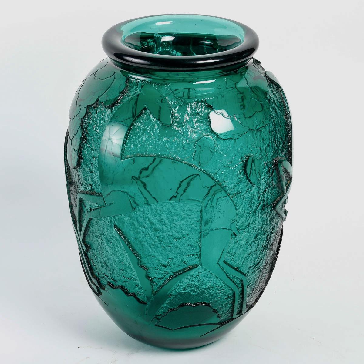 A Daum Nançy Art Deco acid-etched deep green glass vase, circa 1930

Rare and important vase «aux biches» in thick glass tinted green with decoration in relief with acid 
Signed «Daum Nancy France» 
Circa 1930

Daum is a crystal studio based in