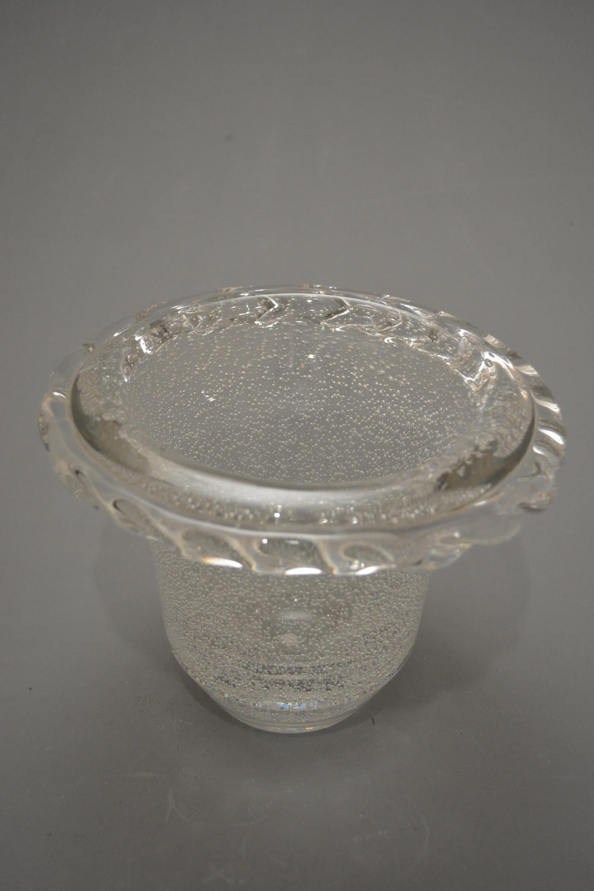 Crystal bubbled vase decorated with a crystal plait applied on the rim.

Production. Daum

Etched sign: Daum “Cross of Lorraine” Nancy France

Measures: High. 18 cm. 




  