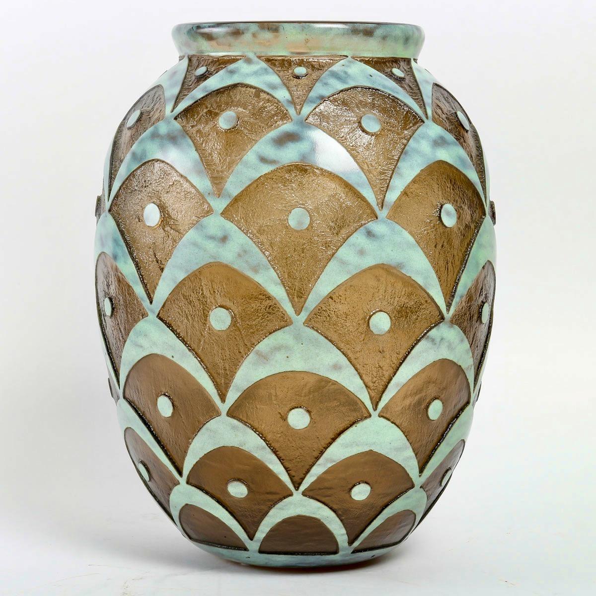 A Daum Art Deco smoky glass 'Peacock Feather' vase, 
circa 1925, 
Engraved Daum Nançy, France with cross of Lorraine
With mottled and polished flashing, deeply acid-etched.

Daum is a crystal studio based in Nancy, France, founded in 1878 by Jean