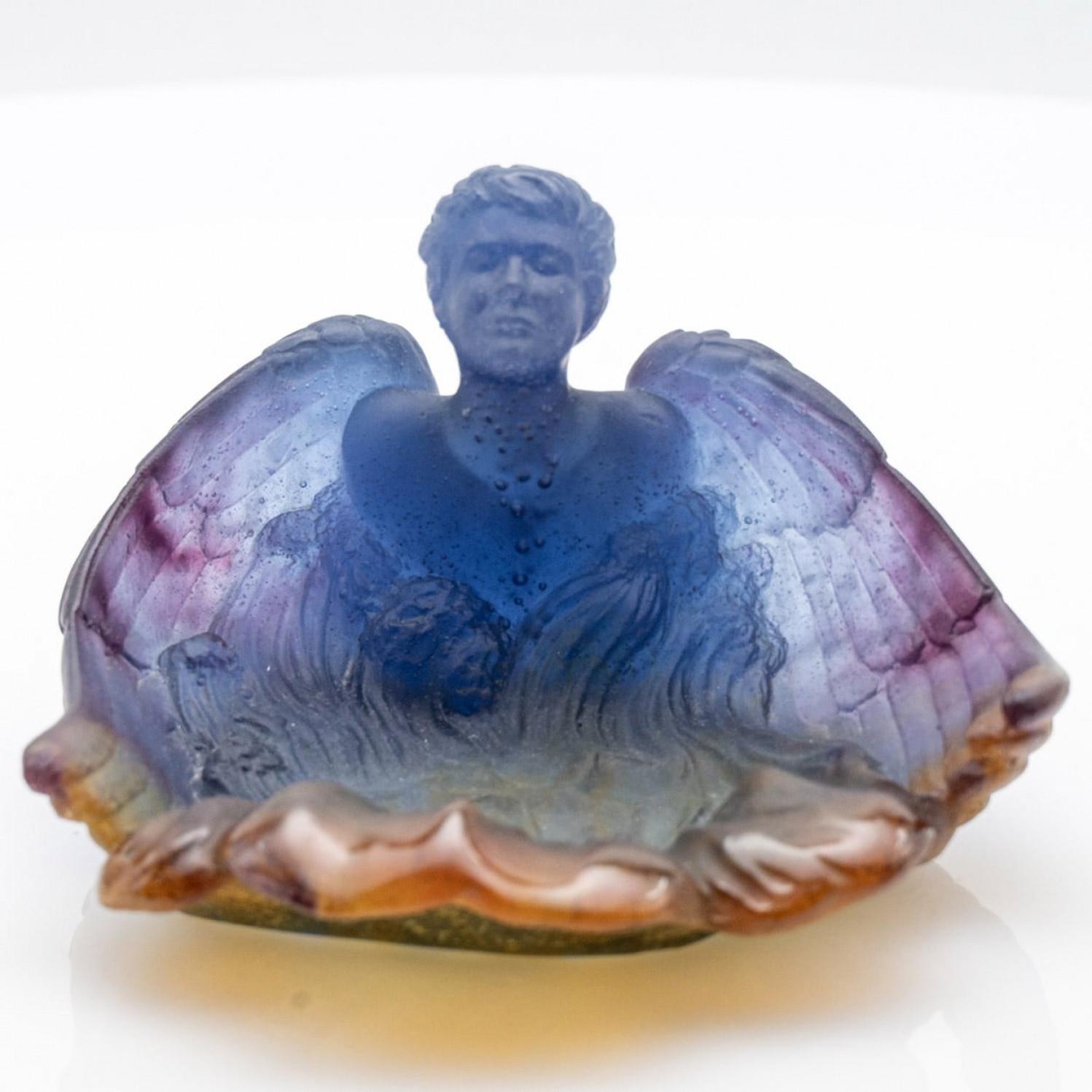 Luxury at its finest, high-end glass bowl with a blue angel by Daum, France.

The bowl is made of the wings of the angel and is made of art glass. The different vibrant colors create a real art piece.

Founded in 1878 in Nancy, France, Daum has been