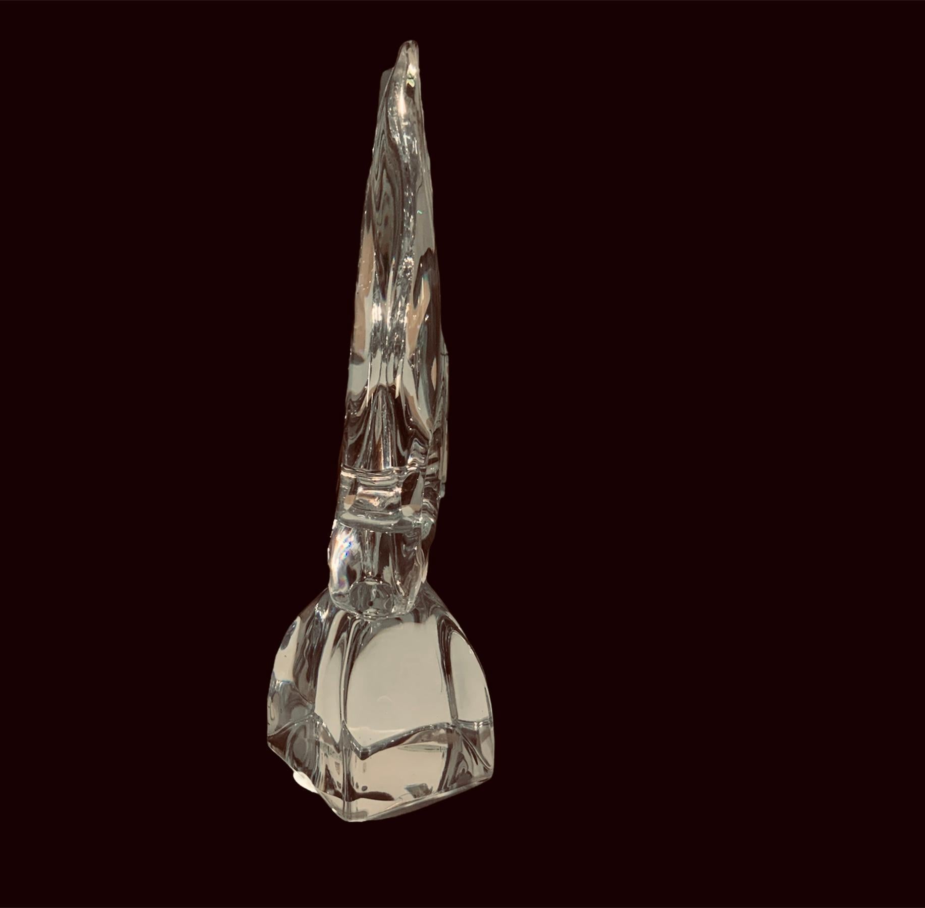 This is a Daum clear crystal angelfish sculpture. It depicts a large clear crystal angelfish figure over a clear crystal dome shaped base. The Daum, France acid etched hallmark is in one of the sides of the base.