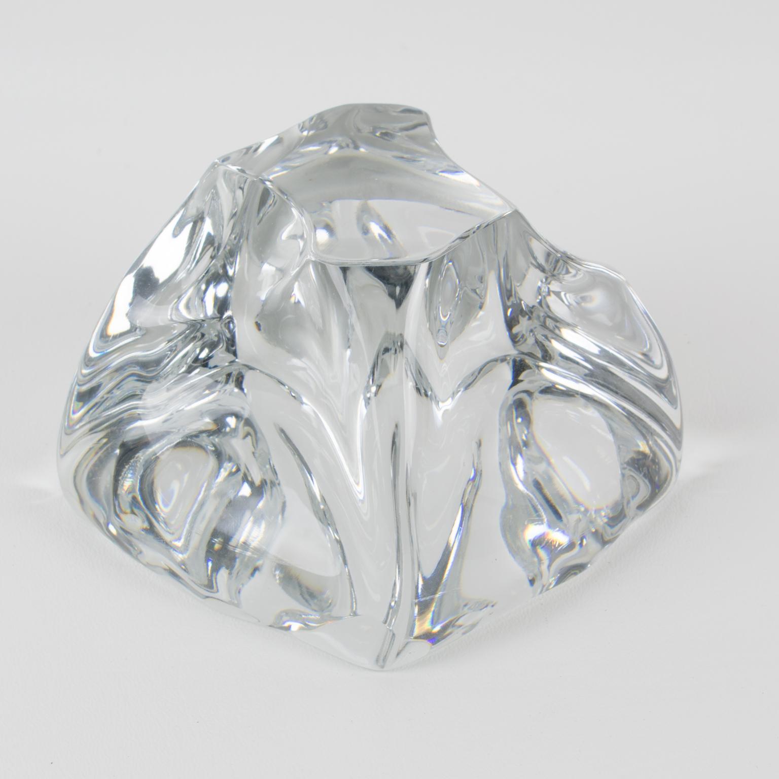 This stunning crystal abstract freeform desktop paperweight is by Daum. The piece was crafted in France circa 1950. The sculpture-paperweight boasts a typical design of the 1950s: a mouth-blown clear crystal in an abstract figure in a curved