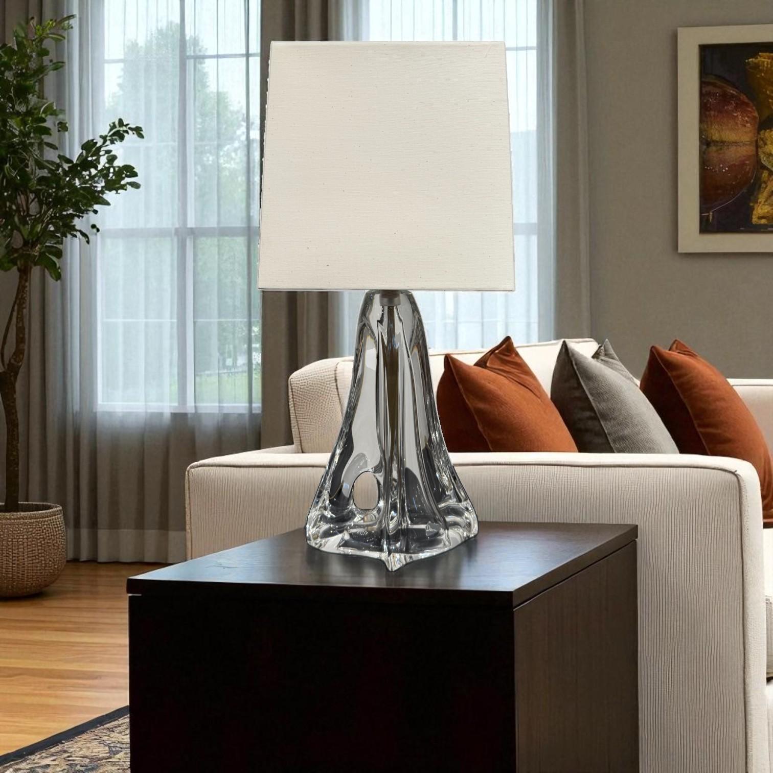 Table lamp by Daum, one of France’s most celebrated glassmakers, renowned for its artistry and refinement since 1878. This exceptional piece, dating from the mid-20th century, showcases the house’s signature mastery of crystal, blending technical