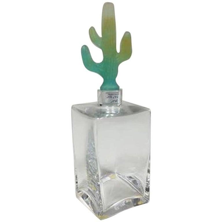 Daum crystal decanter with a pâte de verre cactus shaped stopper. The designer Joseph Hilton McConnico began his collaboration with Daum France in 1987, and was the first American whose work became part of the Louvre's permanent Decorative Arts