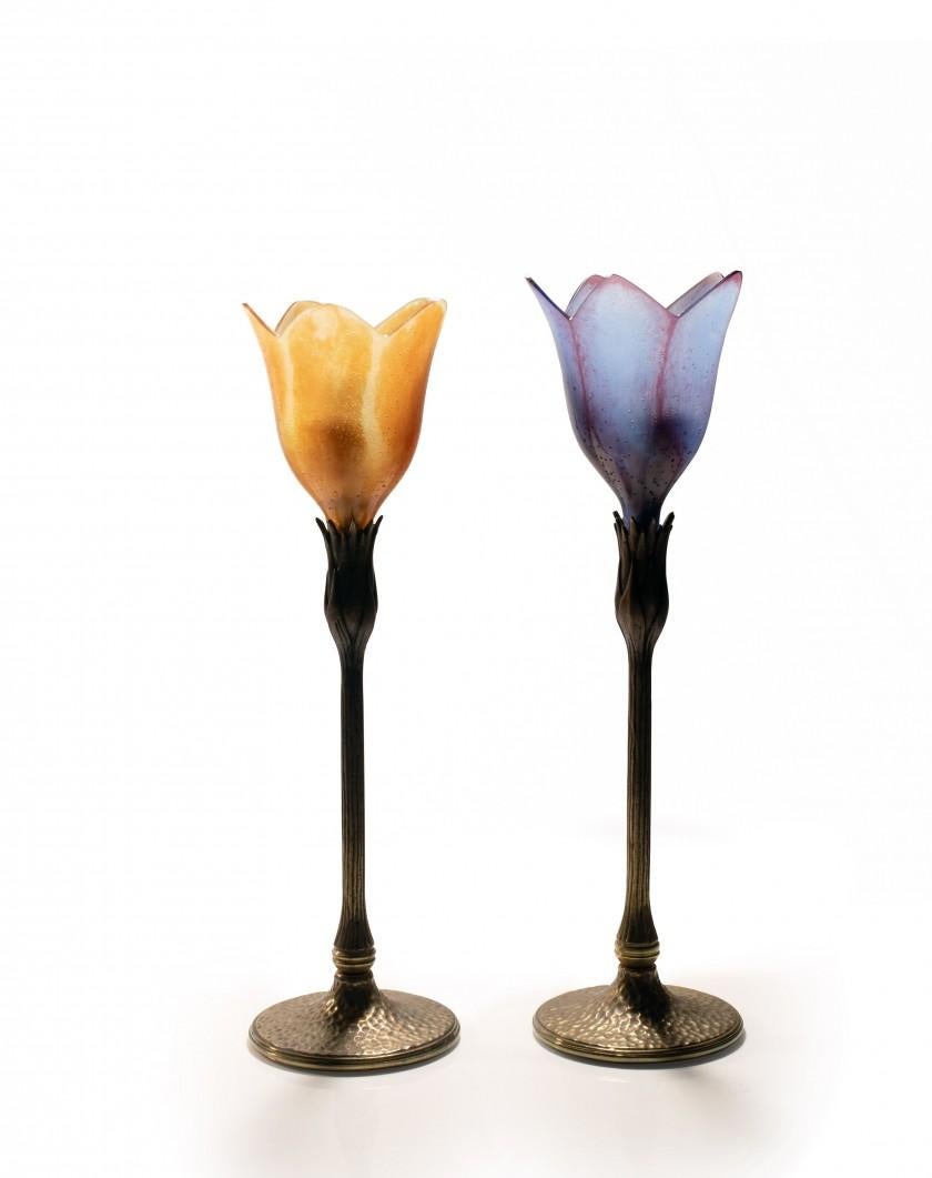 Pair of lamps Daum, France
Magnolia model
In pressed-molded glass paste and tinted yellow and purple, the grooved bronze shaft with brown patina in imitation of a branch, surmounted by a lampshade forming a flower
Signed 