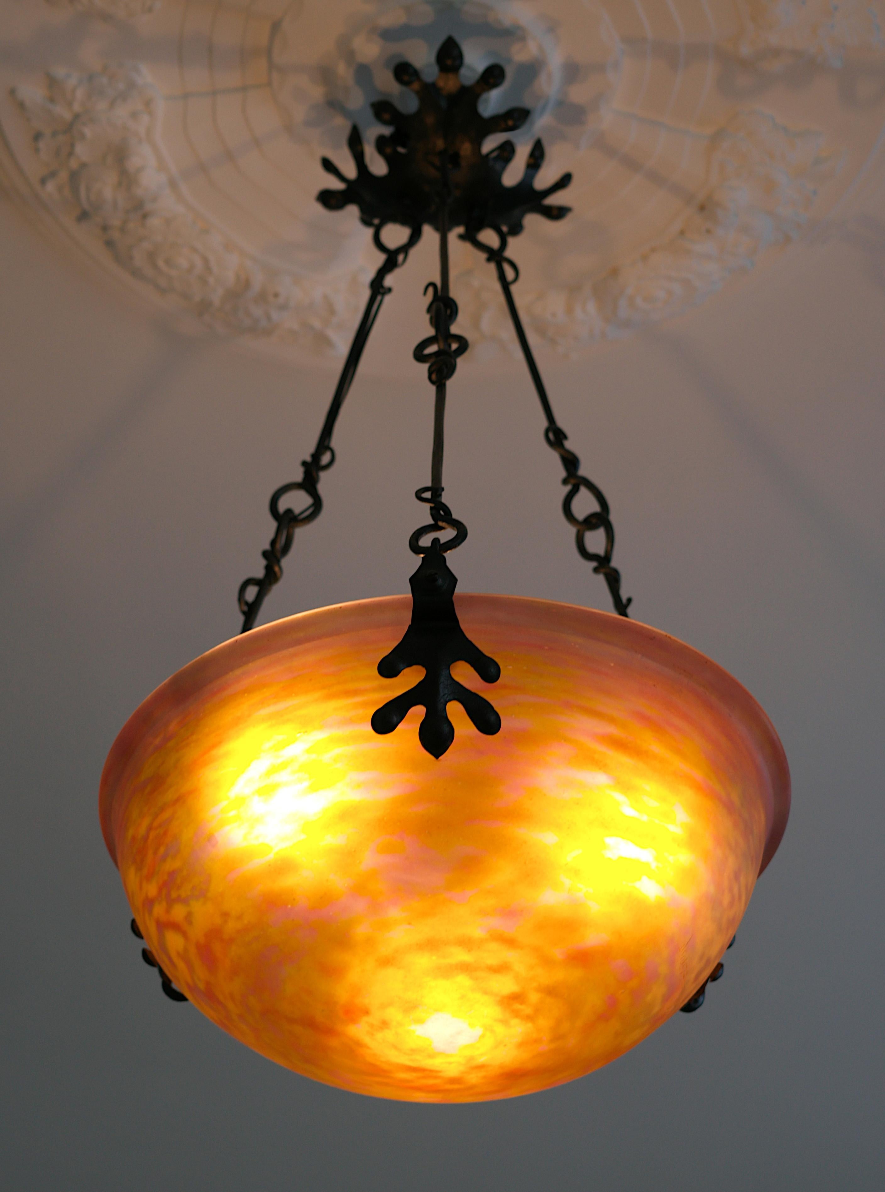 French Art Nouveau - Art Deco pendant chandelier by DAUM (Nancy), France, 1910-1915. New Style - Transitional period between Art Nouveau and Art Deco. Blown double glass shade hung at its wrought-iron frame. Colors : pink and yellow. Height :