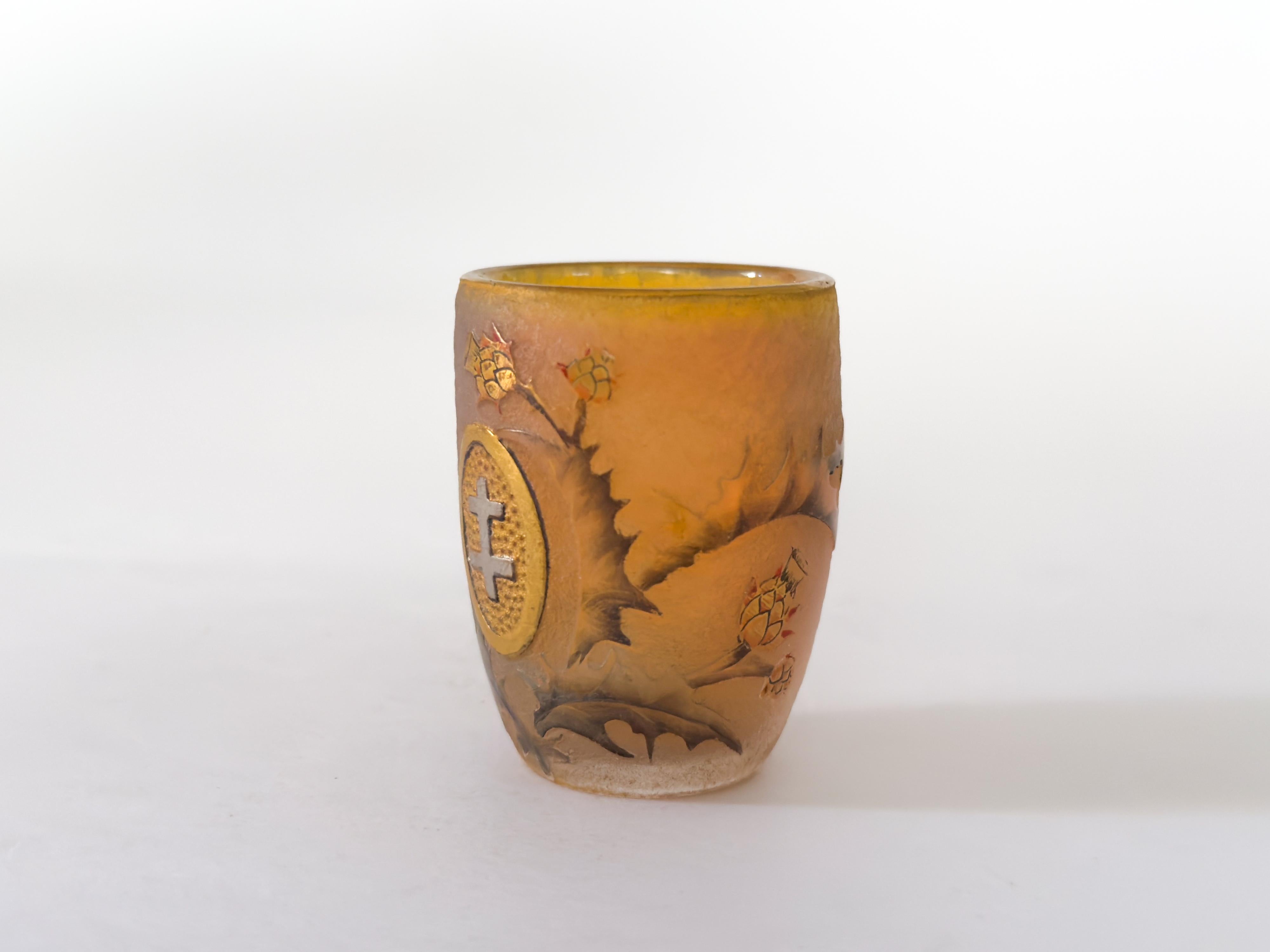 This Lorraine Cross glass chalice by Daum, created in 1906, showcases the delicate artistry and craftsmanship of the renowned French glassmaker. The chalice features multi-layered glass with an acid-etched and polychrome enameled decoration on a