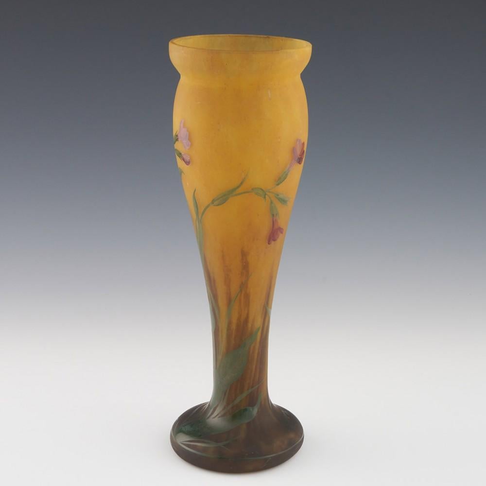  Heading : Mado Nancy Daum vase
Date : c1925
Period : 20th Century
Origin : The Belle Etoile, Croismare, France
Colour : Mottled orange and lemon ground enamelled in puce orange and green. The foot cased in satin finish clear glass
Bowl : Decorated