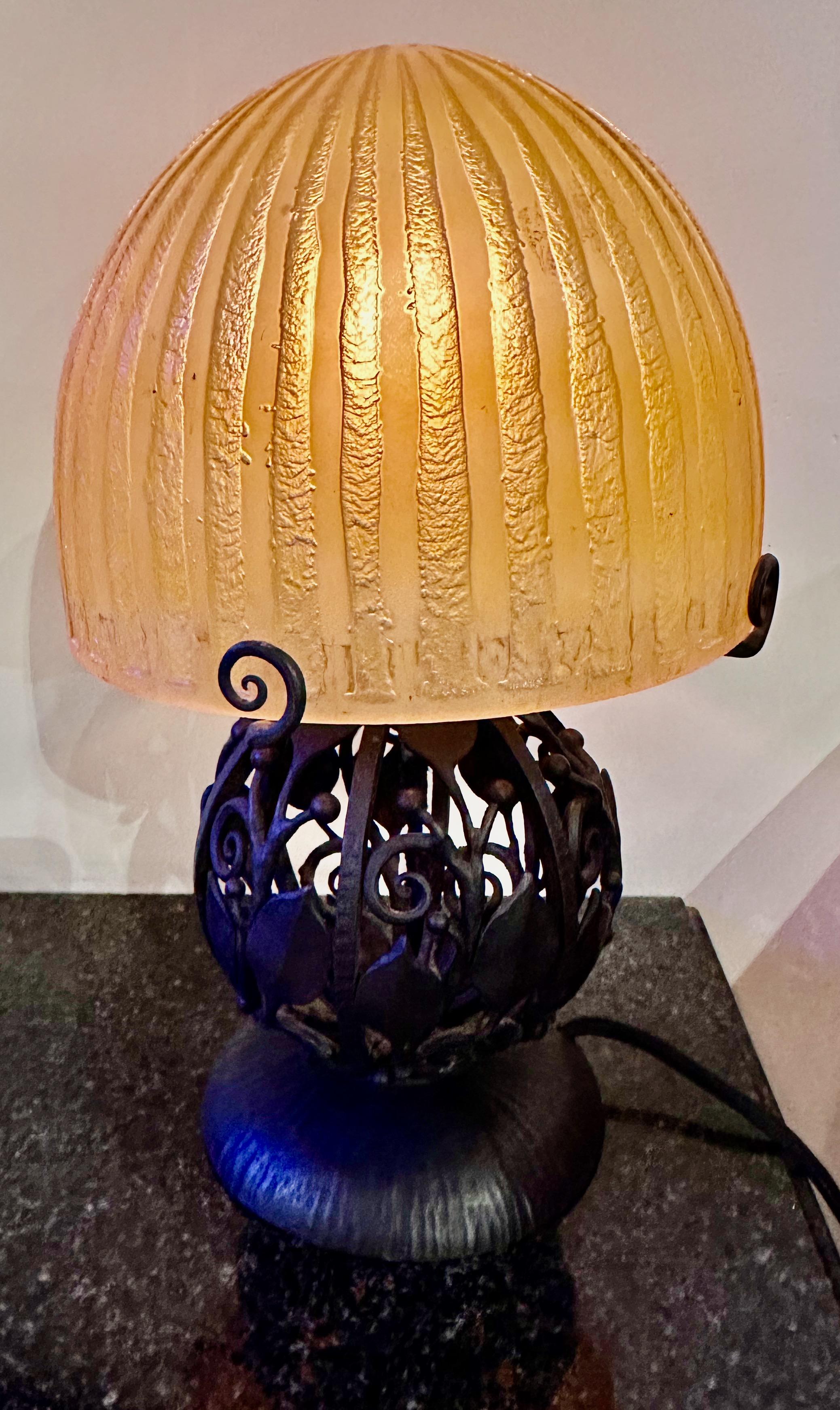 Art Deco acid-etched French Globe Iron Table Lamp by Daum and Katona. This beautiful and unusual lamp is crafted in the “pate de verre” technique of thick glass heavily etched and carved in geometric, stylized pattern accented with hand-made