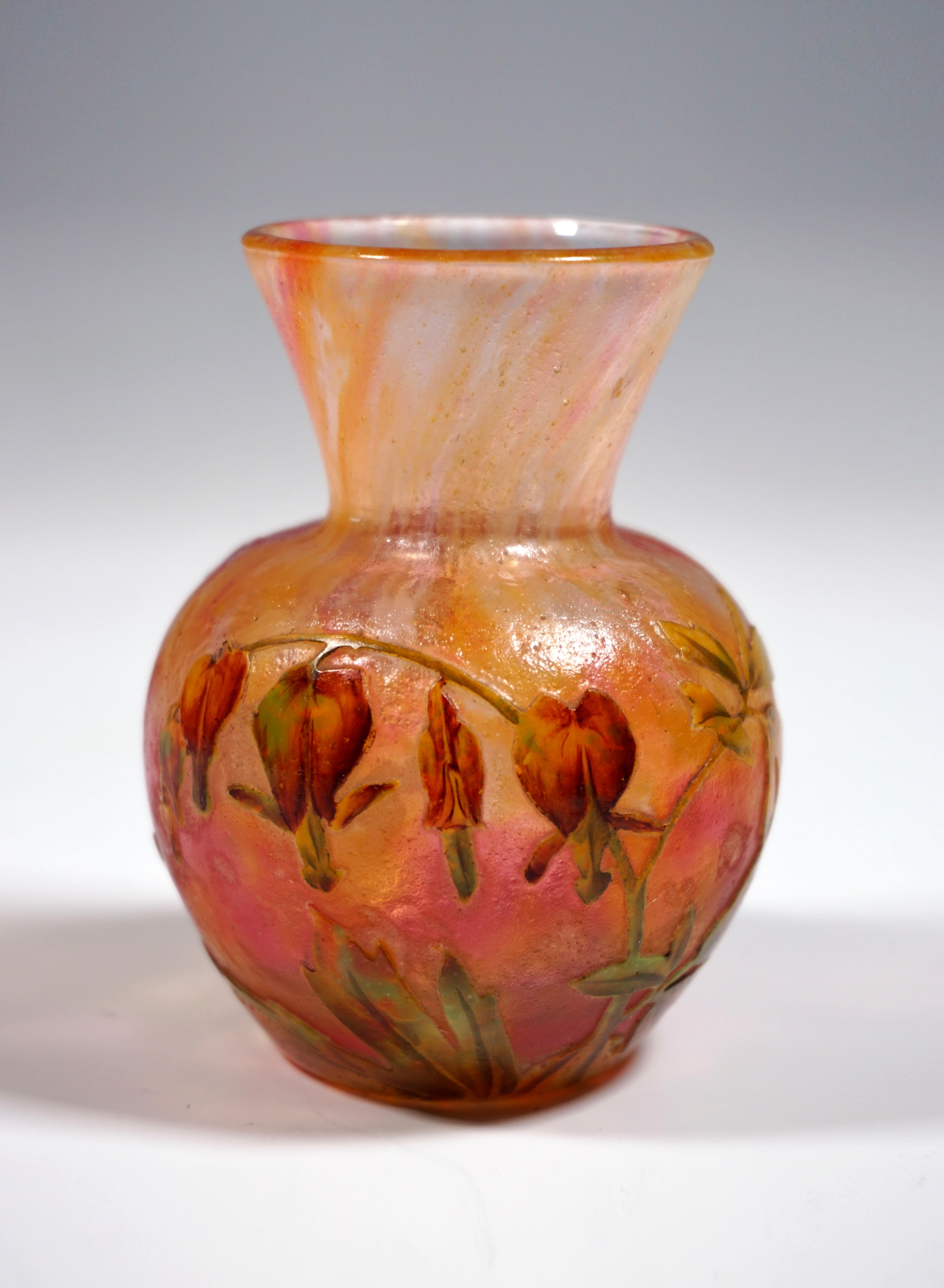 Very rare and exceptional piece of Art Nouveau glass:
Small baluster vase, bulbous body with attached, funnel-shaped neck. Colorless glass with colored powder inclusions in white, orange and pink, with highly etched 'Bleeding Heart' decoration
