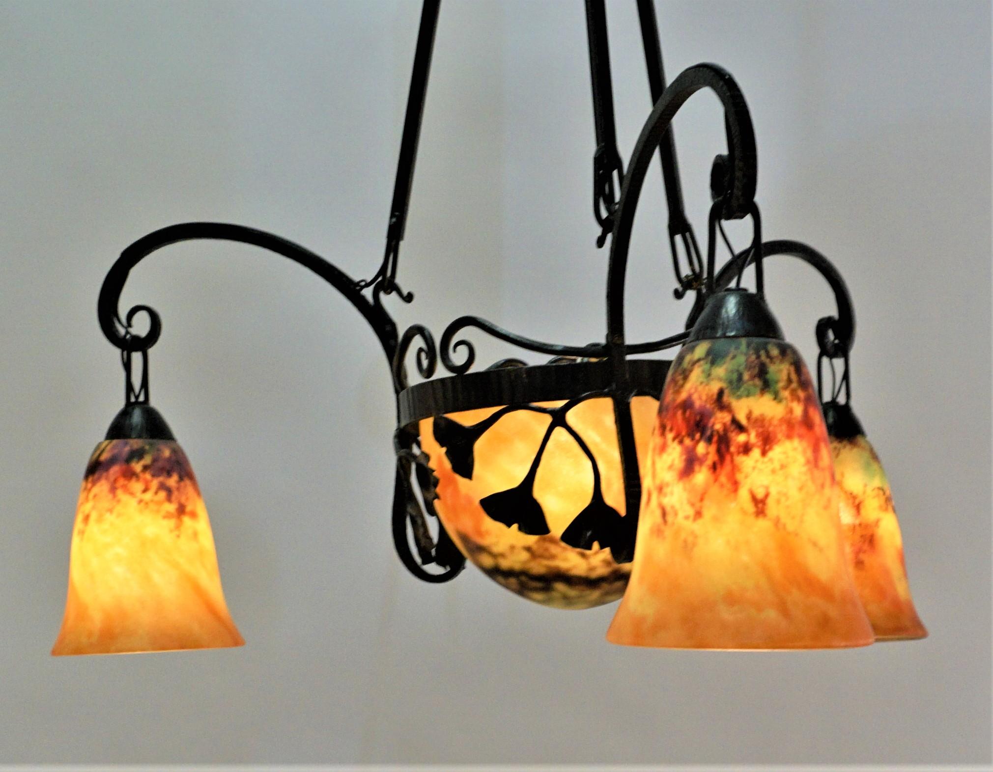 Beautiful hand blown glass chandelier with Ginkgo leaves design iron frame.
Signed Daum Nancy.