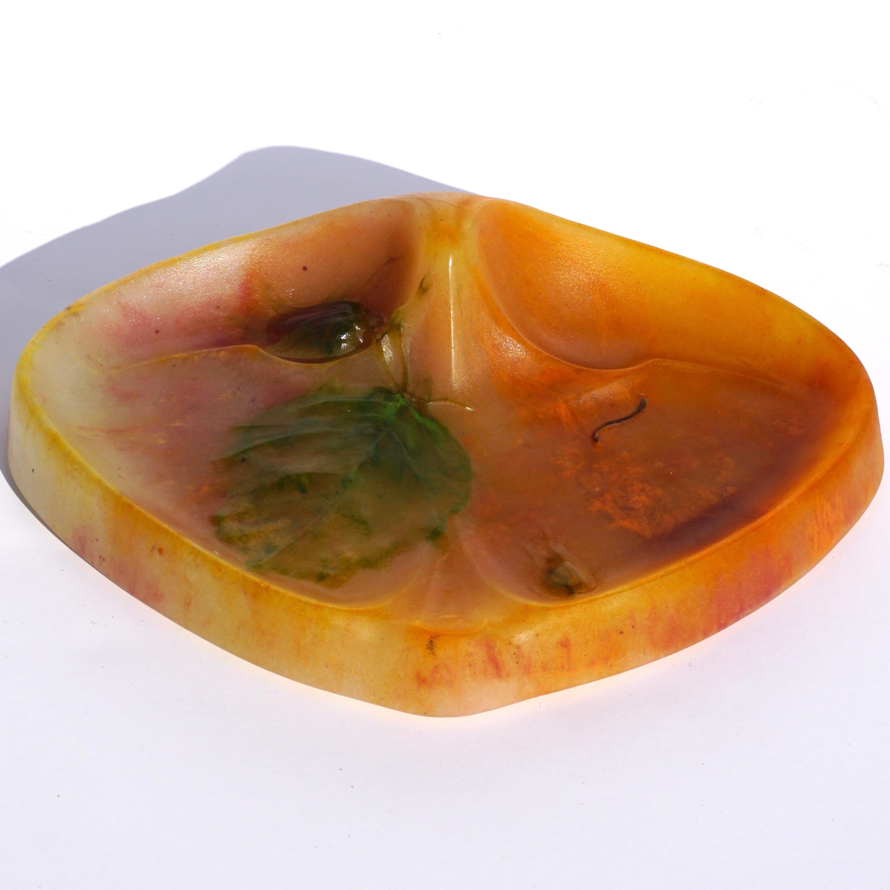A very rare Art Nouveau Daum Nancy pate de verre 'Noisettes' vide poche in orange, reds, greens and yellows. Daum in Nancy was integral is originating the Art Nouveau design of nature in motion through glass, wood and other mediums. This example is