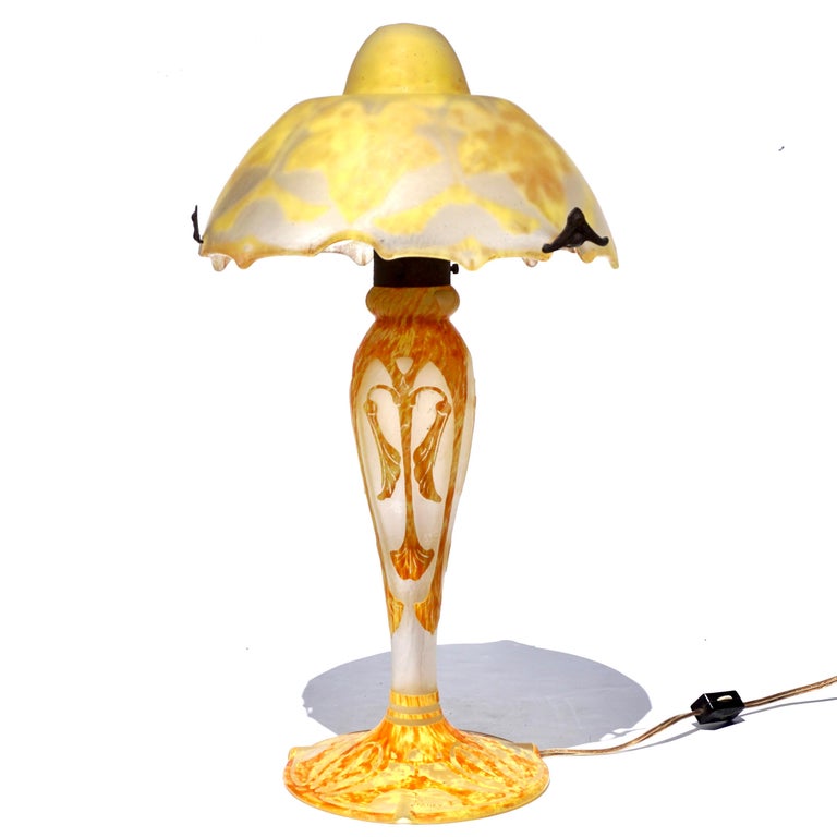 Daum Cameo Glass and Wrought Iron Maple Leaf Table Lamp, circa 1920 Art Nouveau Art Deco design. 

Mottled and variegated glass base with with carved and acid etched Deco symmetrical leaf and seed design signed Daum Nancy with Cross of Lorraine.