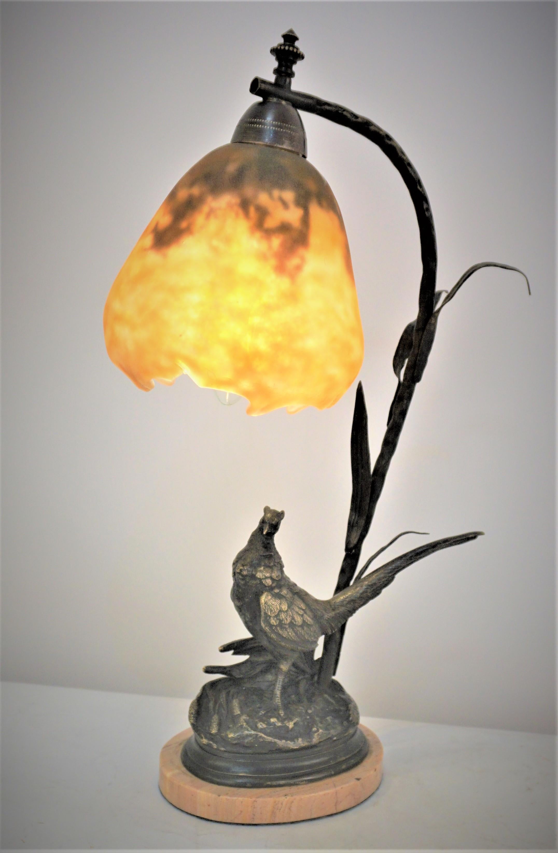 Beautiful bronze bird sculpture Lamp with hand blow glass shade by Daum.