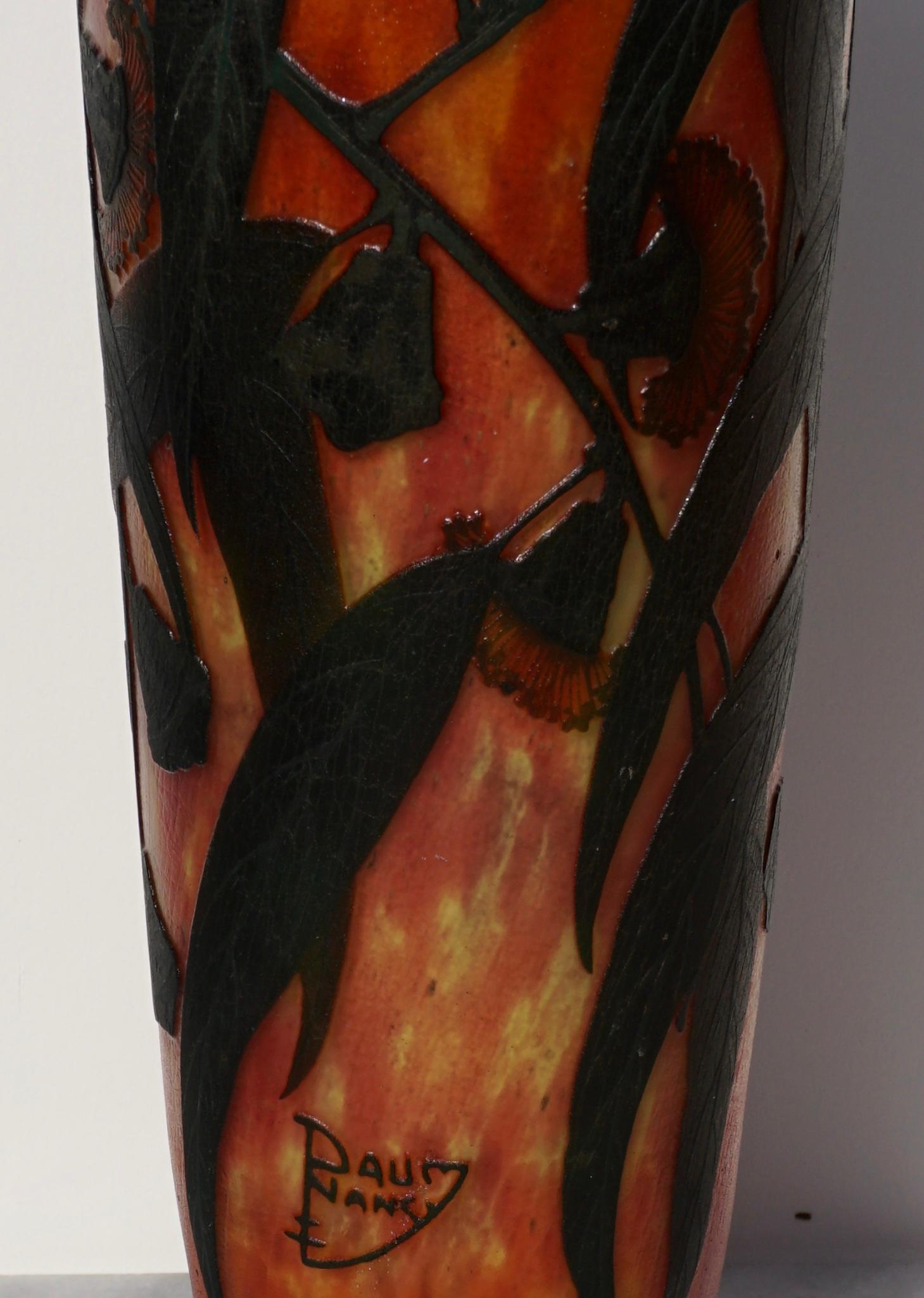 A large and wonderful red and green Art Nouveau deeply carved, acid etched and enameled Daum Nancy glass vase. With several flowers entwined in vines and leaves on a variegated orange, yellow and red background and standing at 12.5 inches.

Signed