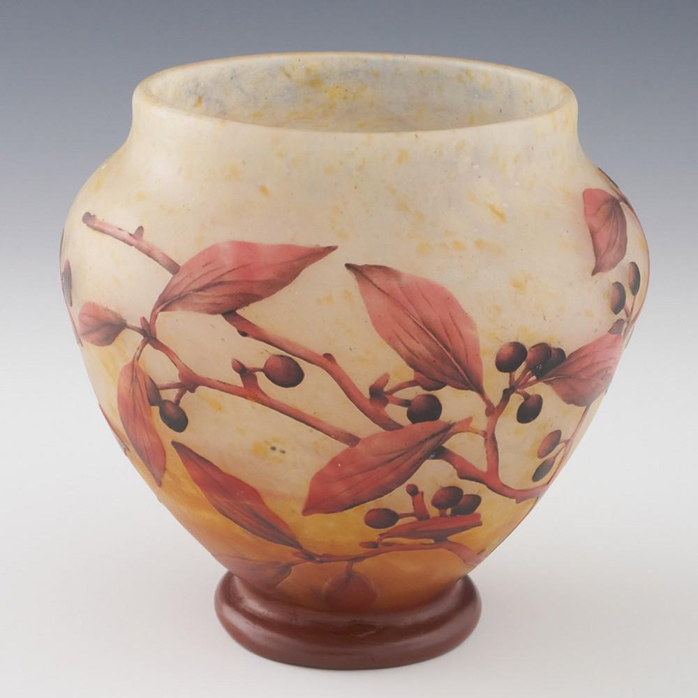 Heading : Daum Nancy cameo glass vase
Date : c1910
Origin : Nancy, France
Bowl Features : Baluster form with mottled off-white and amber glass mottled ground with fushia cameo depicting autumnal spindle berries and leaves
Marks : Daum Nancy