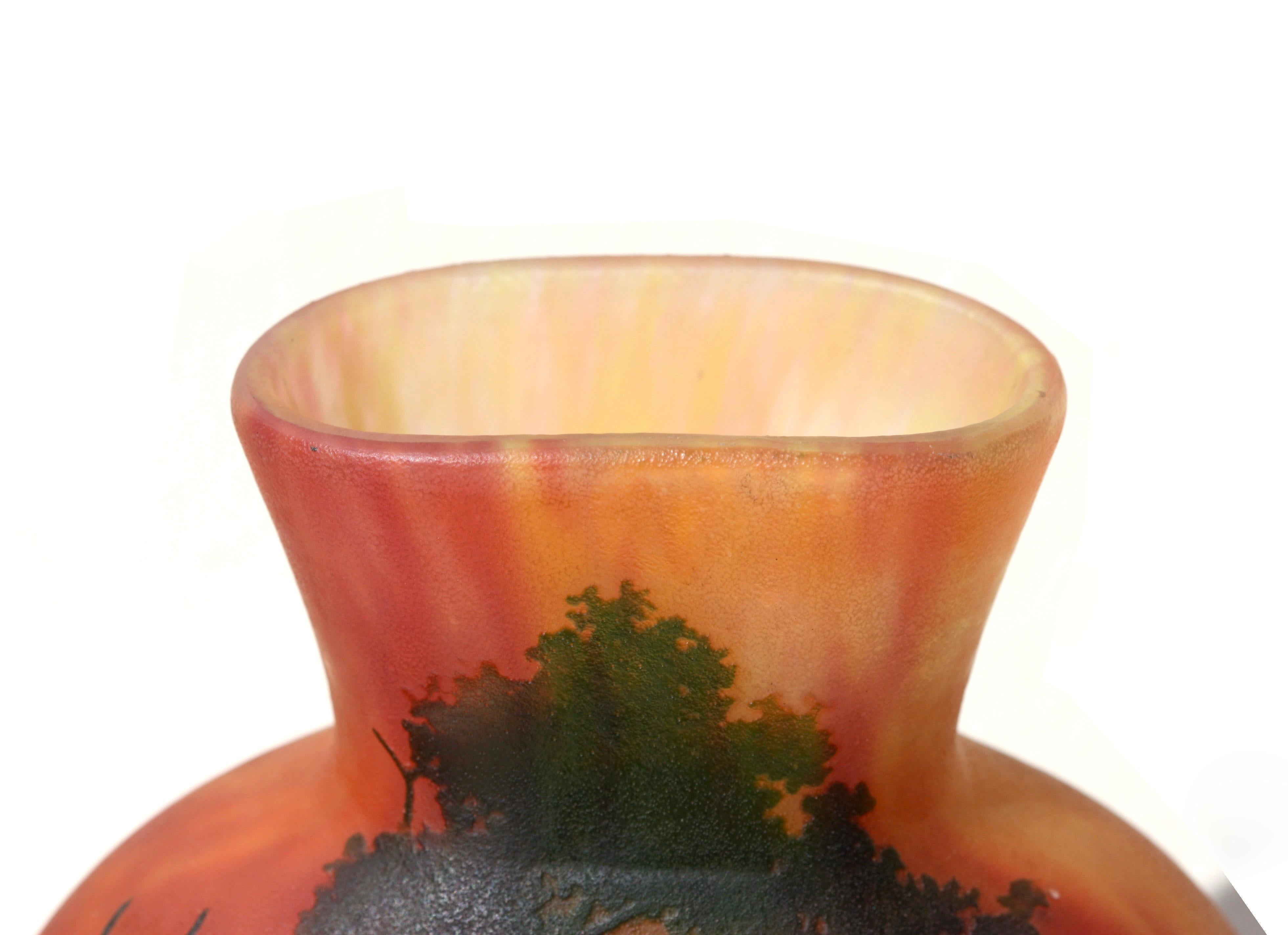 Daum Nancy Cameo glass vase, 
France, circa 1920 
decorated with trees on a mottled orange and brown ground 
cameo mark Daum Nancy with Lorraine cross 
Dimensions 
W.5 1/2 in. x D 2 in. 
W 139 mm x D 50 mm 
Height 
7 3/4 in. 
Catalogue