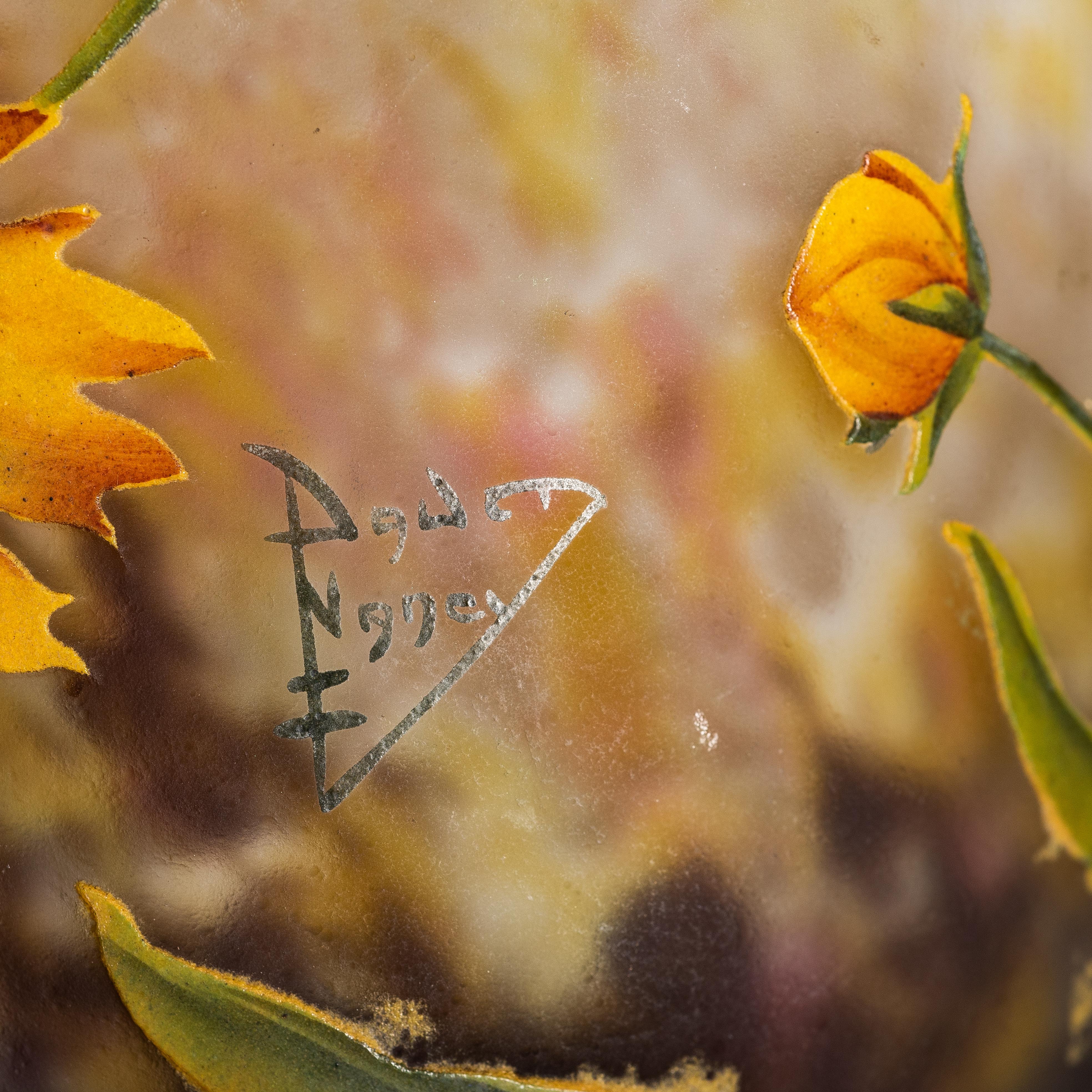 Vase en verre Daum Nancy émaillé et décoré à l'intérieur, 
France, vers 1900-1910
décoré de fleurs jaunes et de feuilles vertes sur un fond marbré rose, blanc et brun.
signé avec marque peinte Daum Nancy avec croix de