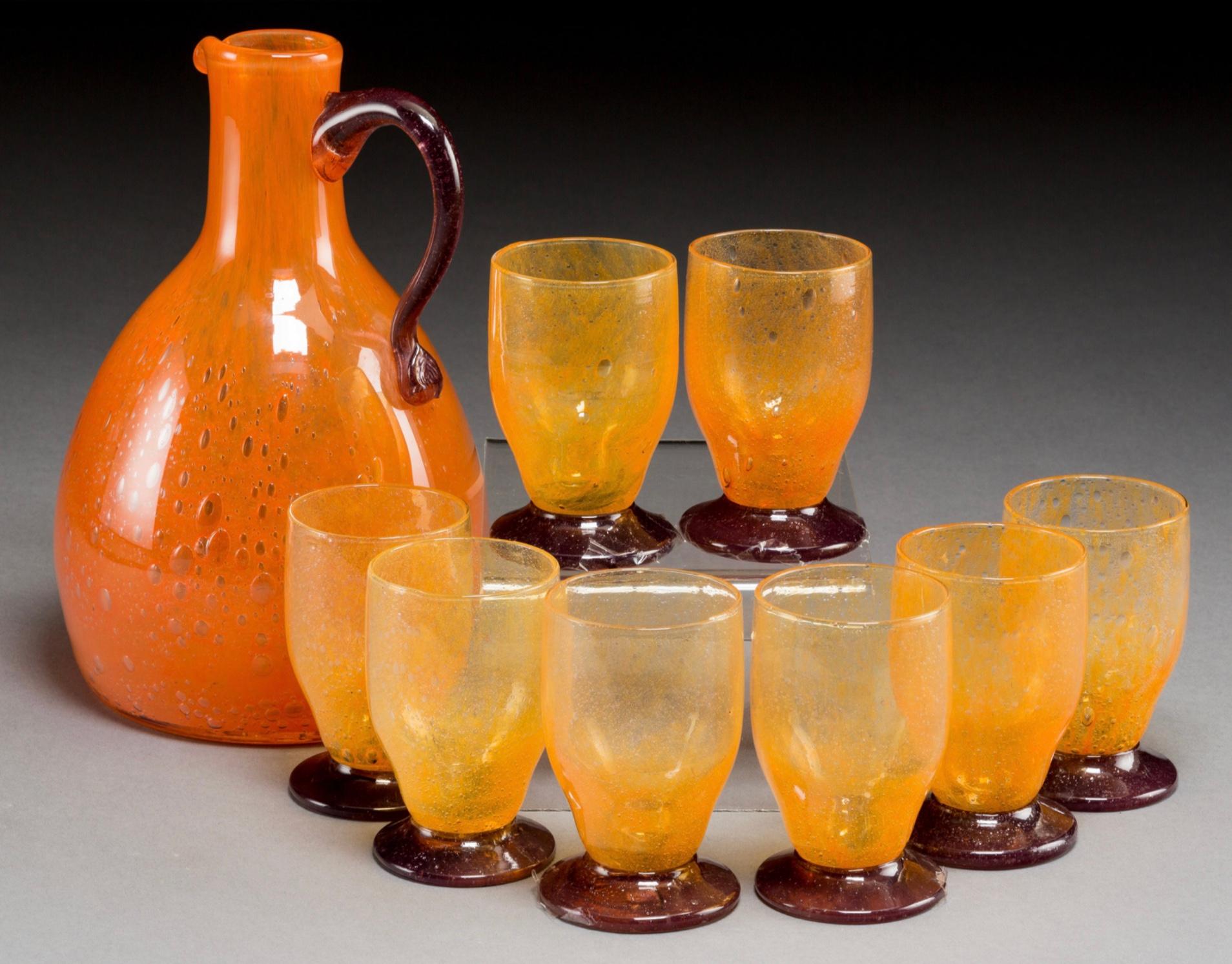 A beautiful set of Art Deco Daum Nancy bubble glass carafe with eight cordials in a sumptuous orange with purple colors, circa 1930.

Engraved Daum Nancy, France

Height: 7.25 inches (carafe)
Diameter: 5 inches (carafe)
Height: 3.15 inches