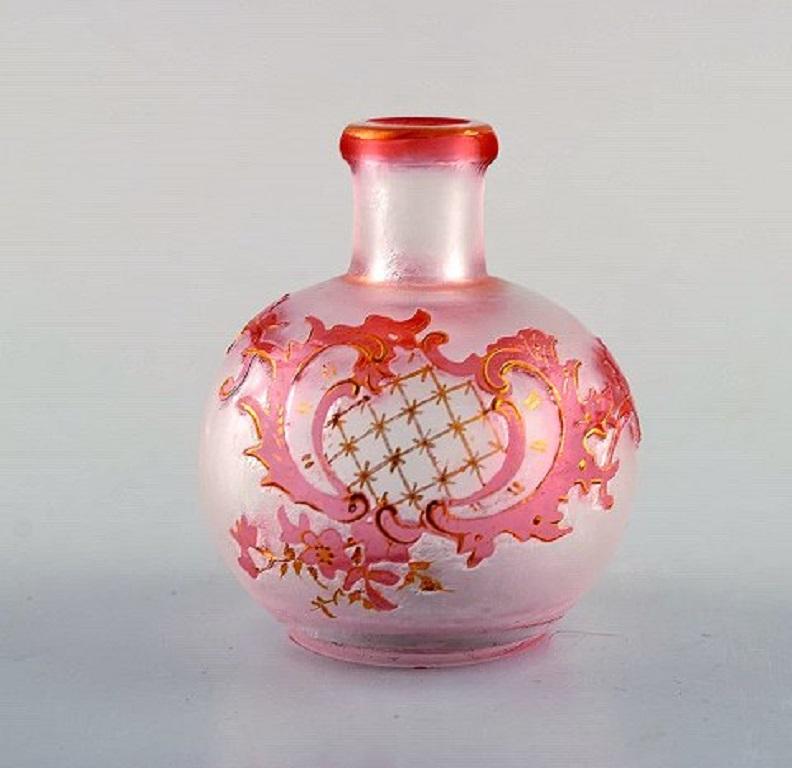 Daum Nancy, France. Pink Art Nouveau miniature vase in hand painted, mouth blown art glass. Floral and gold decoration, circa 1900.
Measures: 7 x 6 cm.
In very good condition.
Signed.
  