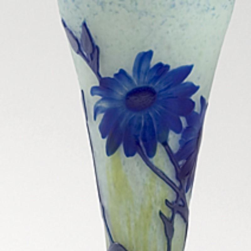A French Art Nouveau wheel-carved cameo glass vase by Daum Nancy, featuring a decoration of blue flowers and light blue or grey stems and leaves on an opaque, mottled white and yellow ground.

 